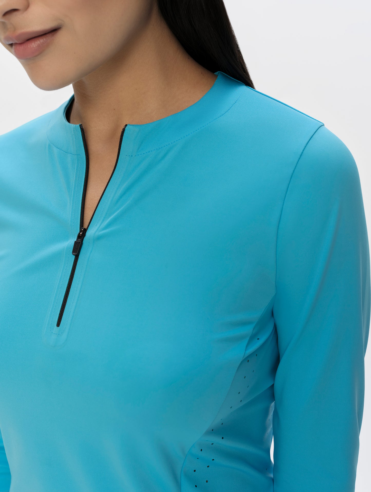 Closeup detailed view of the zippered half-opening on the Kora Sunproof Shirt in Sky Blue from AETHER Apparel.