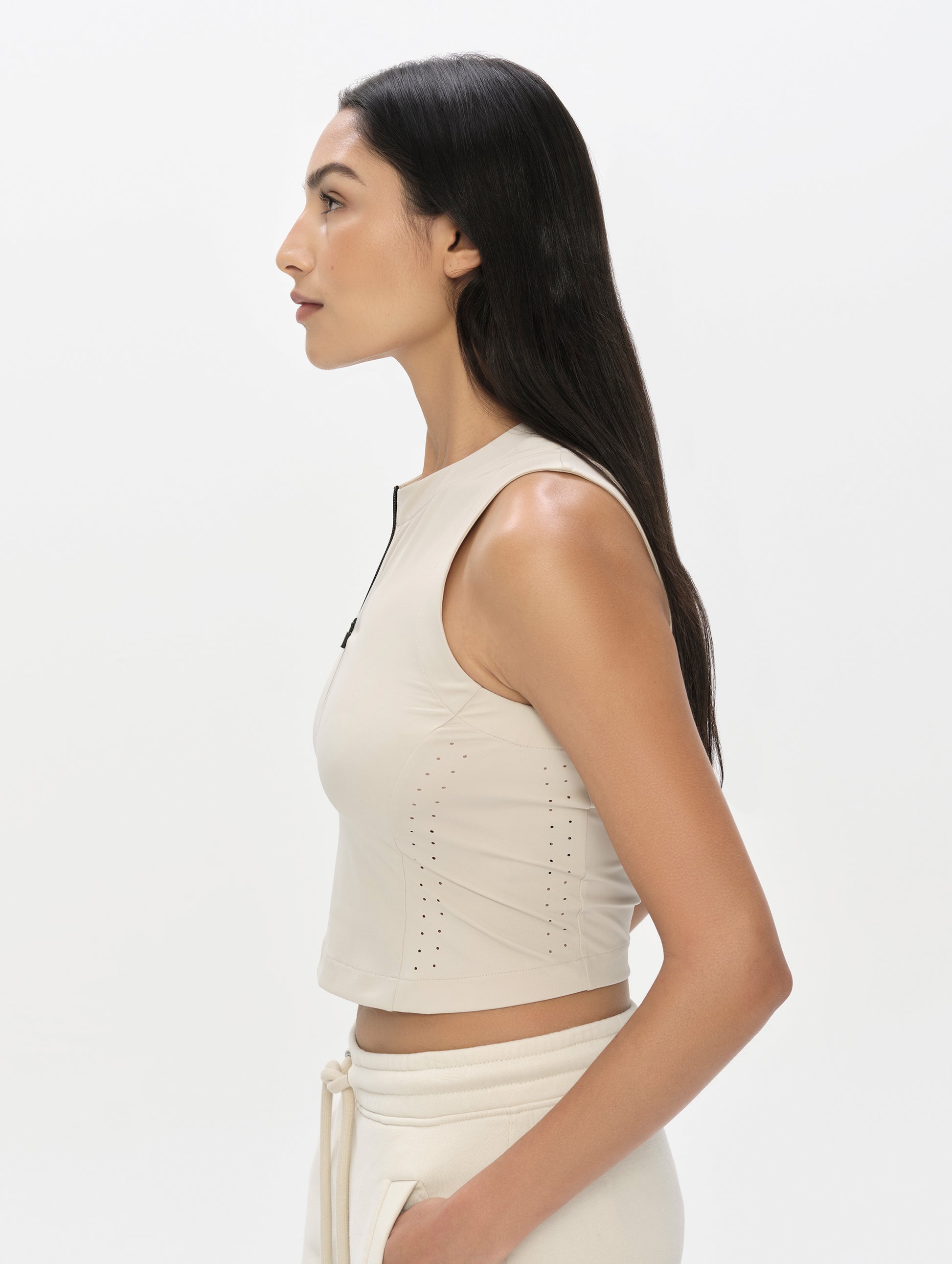 Side profile, upper-body view of woman wearing the Kora Sunproof Tank Top in Sky Blue from AETHER Apparel.