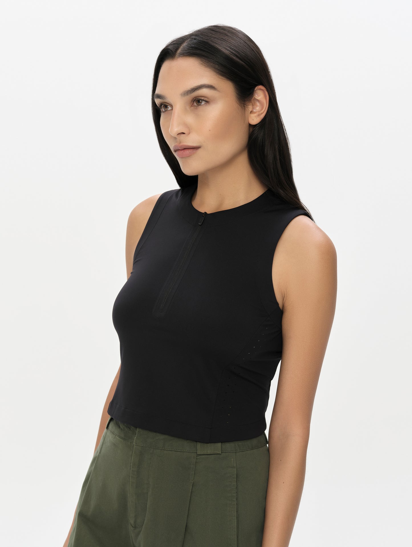 Front, 3/4, upper-body view of woman wearing the Kora Sunproof Tank Top in Onyx Black from AETHER Apparel.