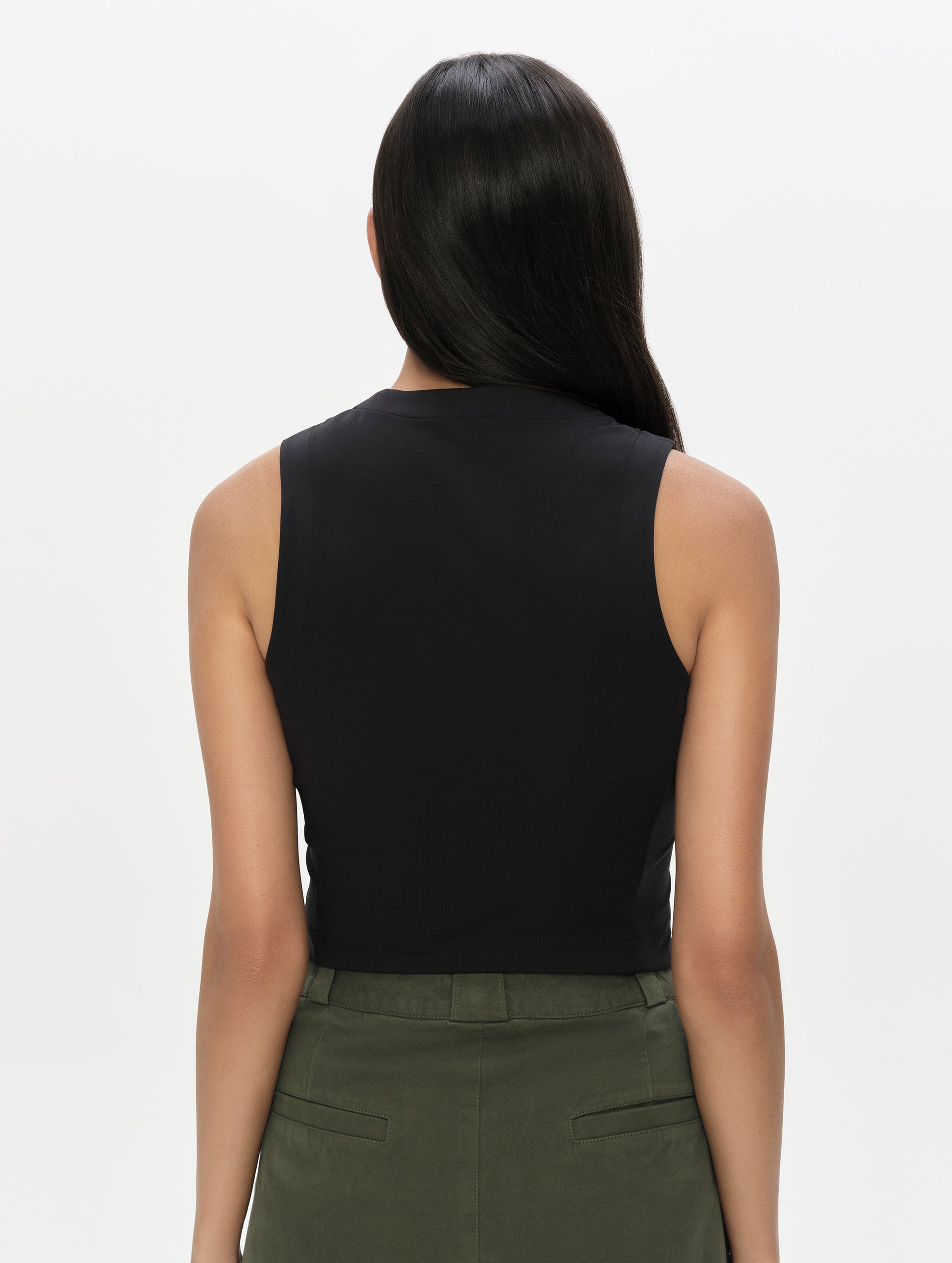Rear, upper-body view of woman wearing the Kora Sunproof Tank Top in Onyx Black from AETHER Apparel.