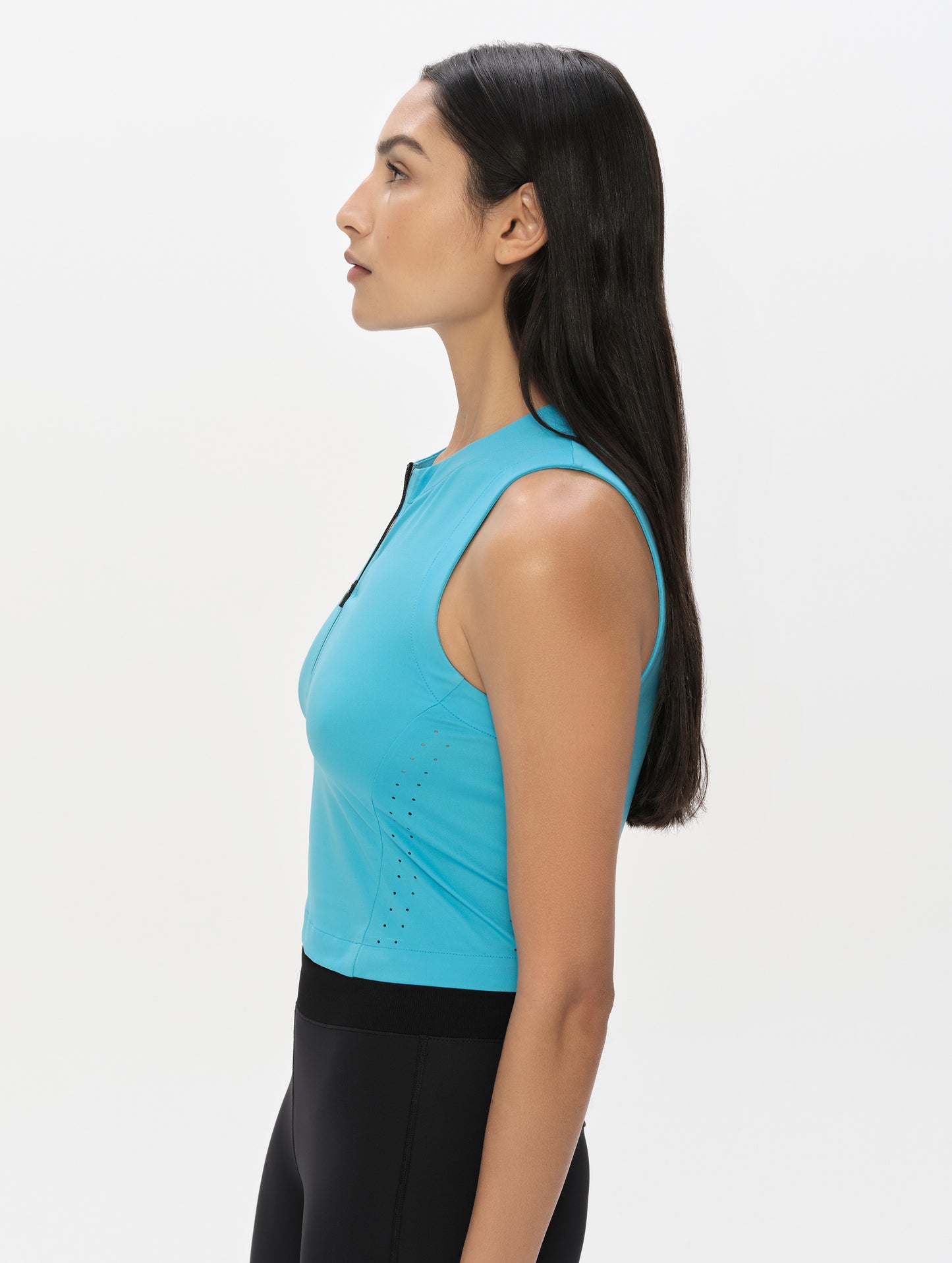 Side profile, upper-body view of woman wearing the Kora Sunproof Tank Top in Sky Blue from AETHER Apparel.