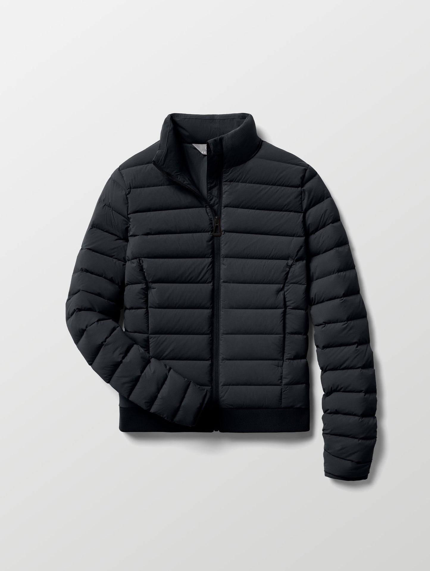 Flat lay of W Launch Full-Zip Jacket NH in Onyx Black from AETHER Apparel.