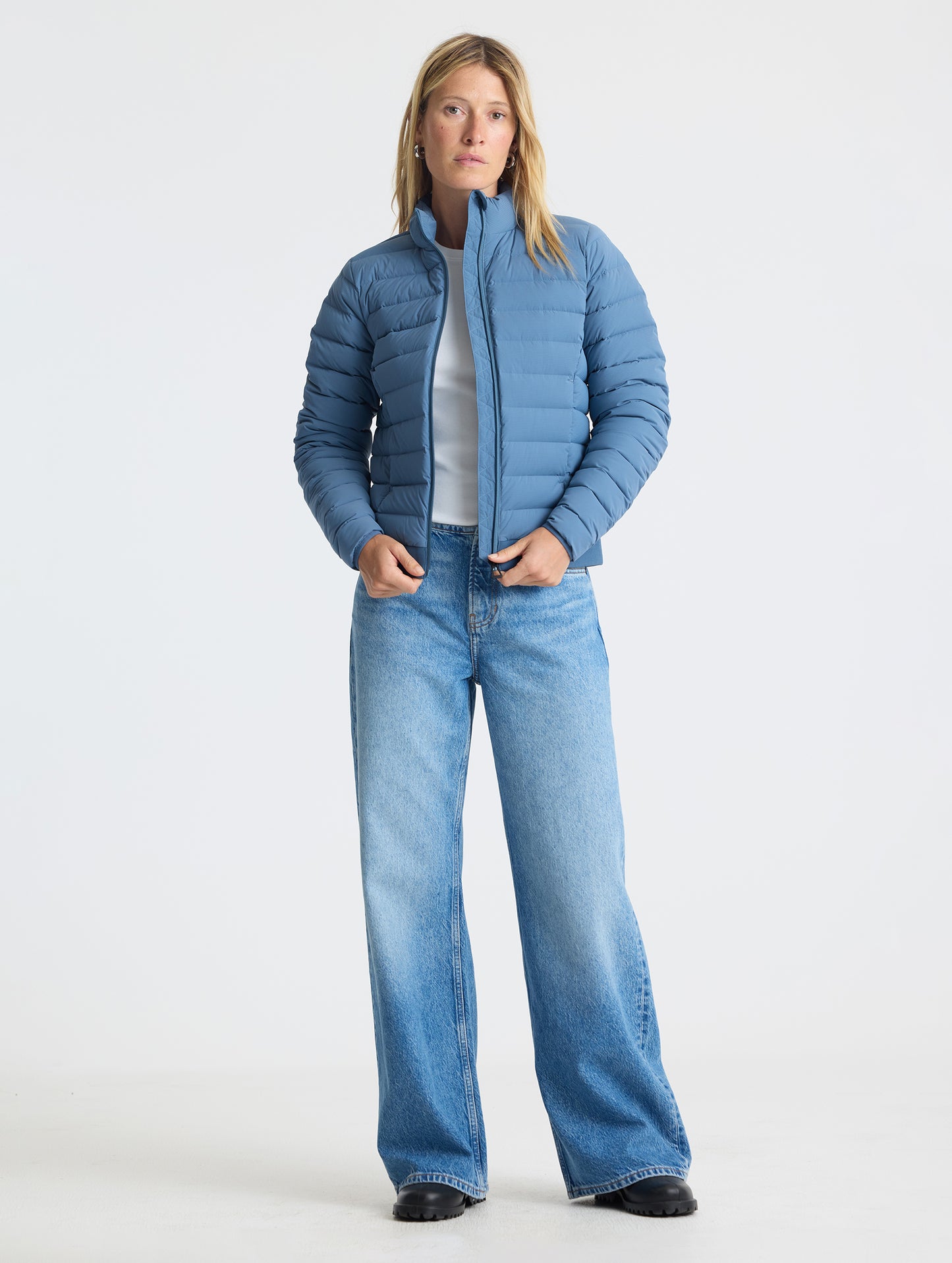 Full body view of woman wearing W Launch Full-Zip Jacket NH in Portal Blue from AETHER Apparel.