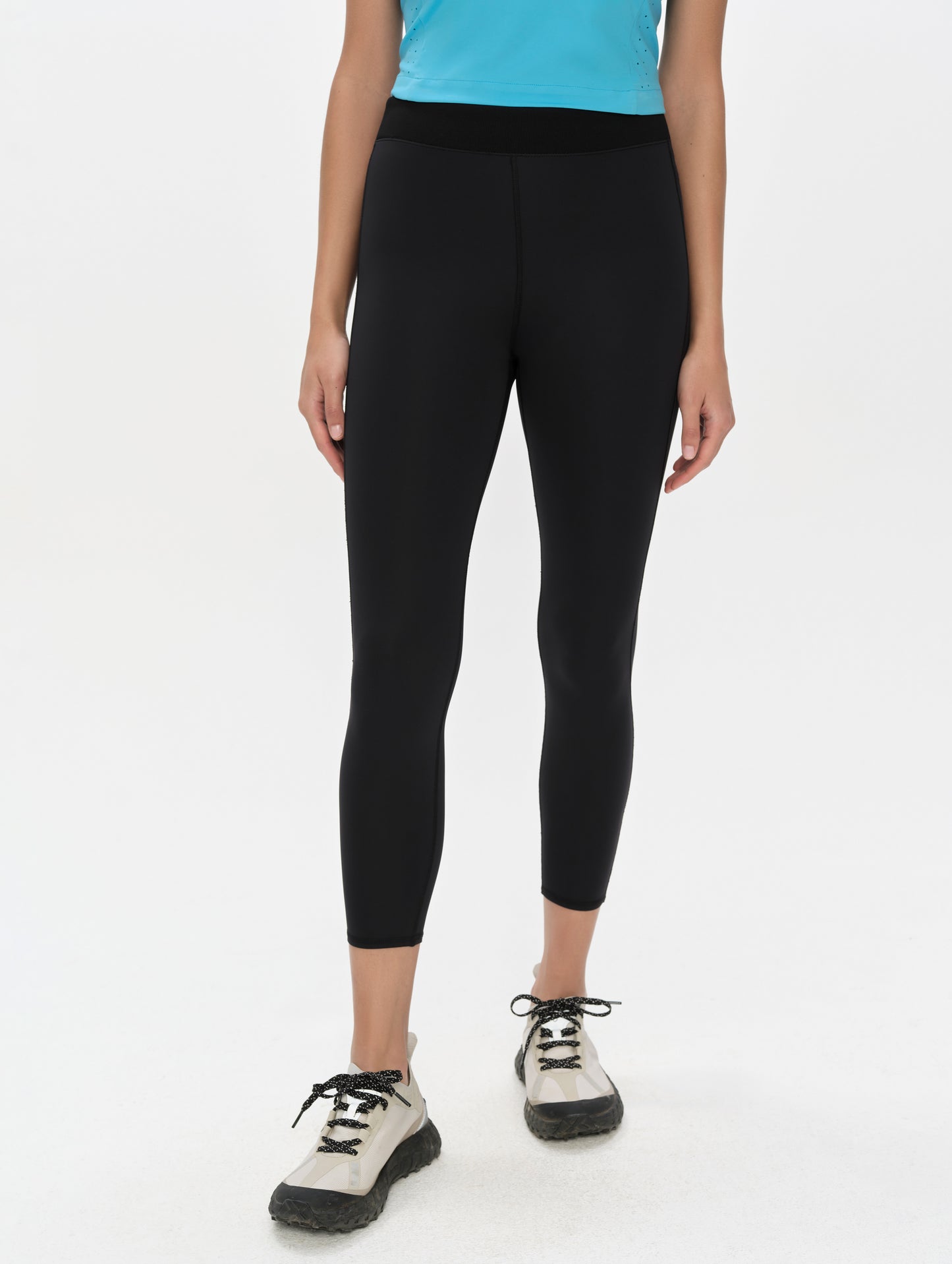 Front, lower-body view of woman wearing the Laurel Legging in Onyx Black from AETHER Apparel.