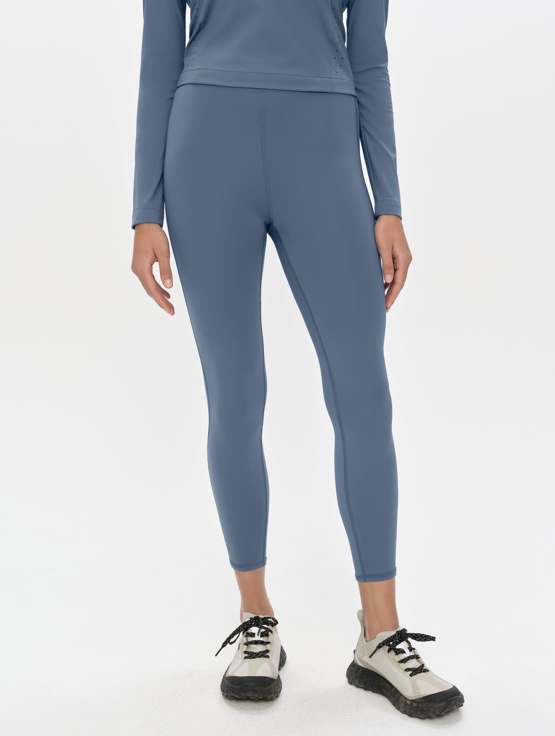 Front, lower-body view of woman wearing the Laurel Legging in Portal Blue from AETHER Apparel.