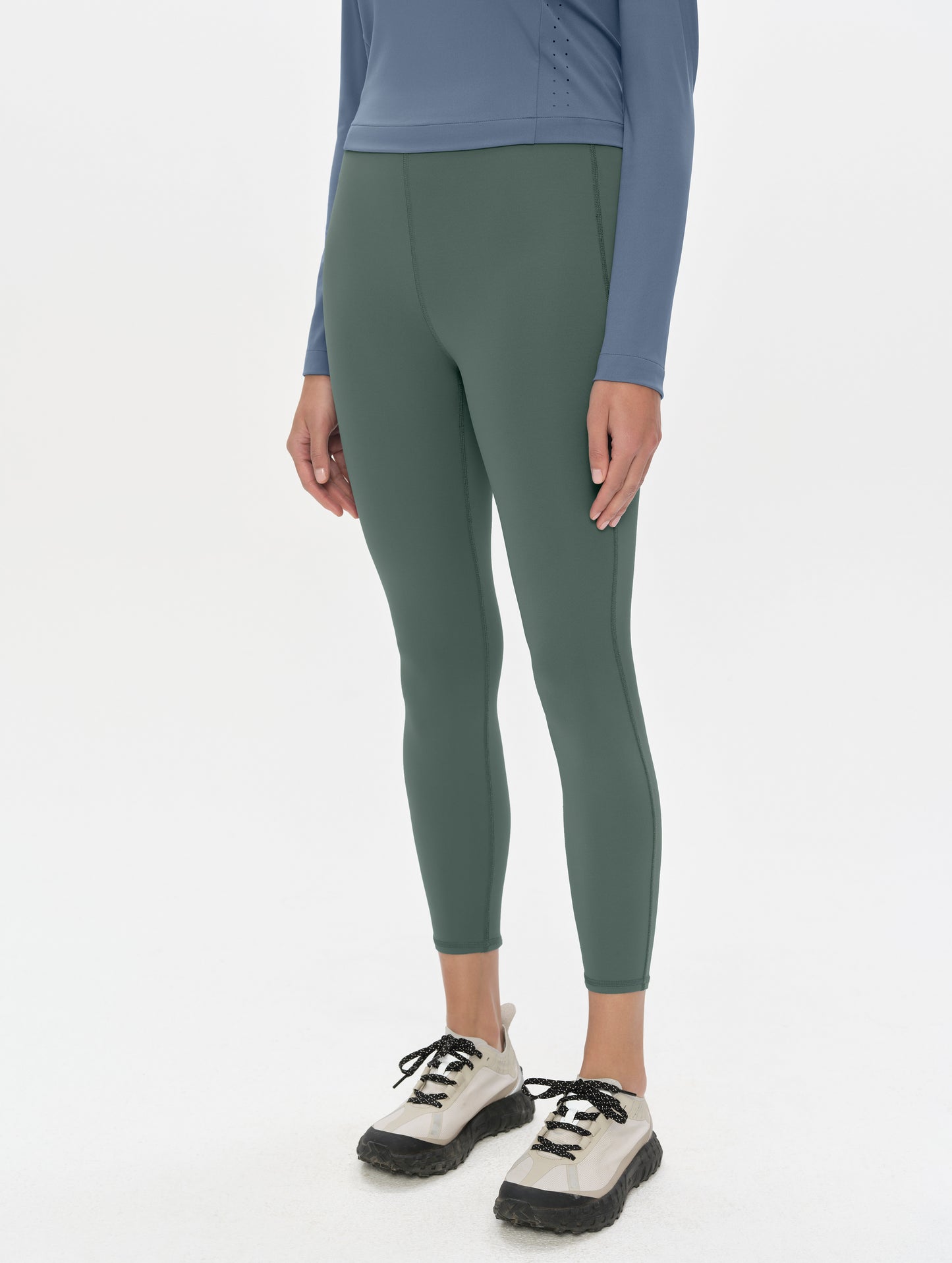 Front, 3/4, lower-body view of woman wearing the Laurel Legging in Saville Green from AETHER Apparel.