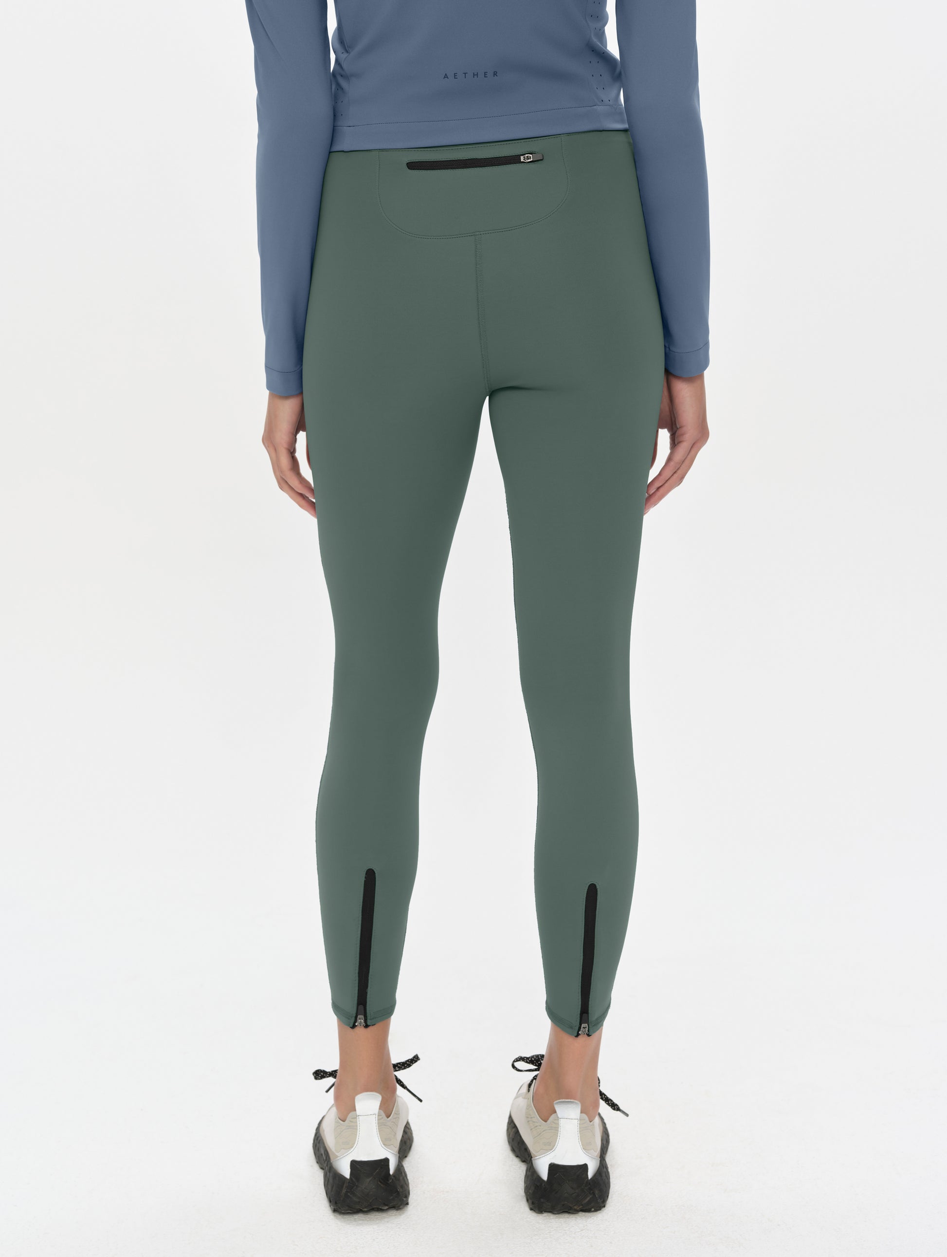 Rear, lower-body view of woman wearing the Laurel Legging in Saville Green from AETHER Apparel.