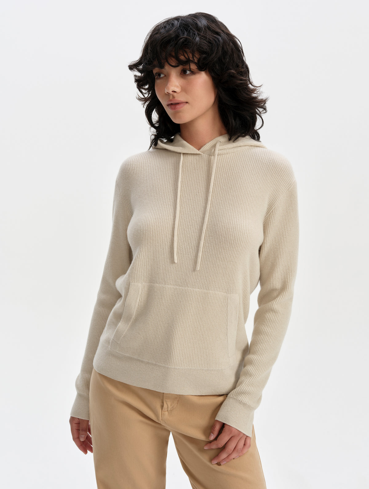 Front upper-body view of woman wearing the Lawrence Cashmere Hooded Sweater in Bone from AETHER Apparel.