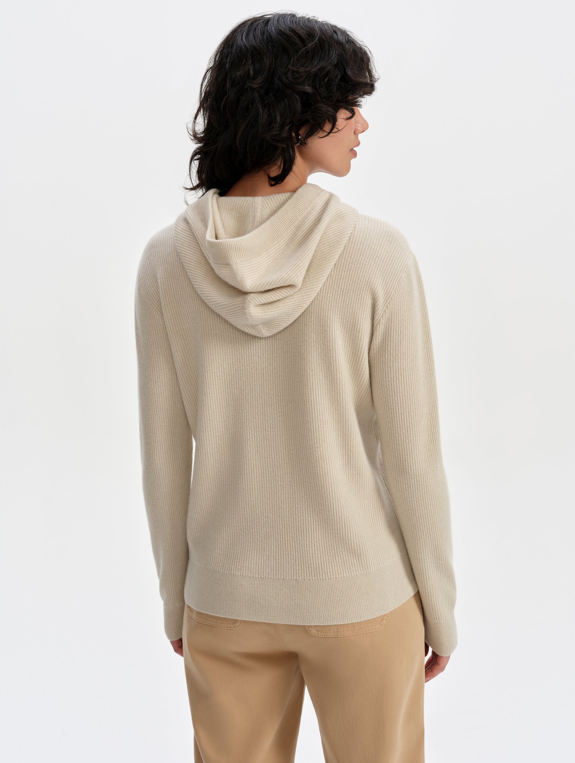 Rear upper-body view of woman wearing the Lawrence Cashmere Hooded Sweater in Bone from AETHER Apparel.