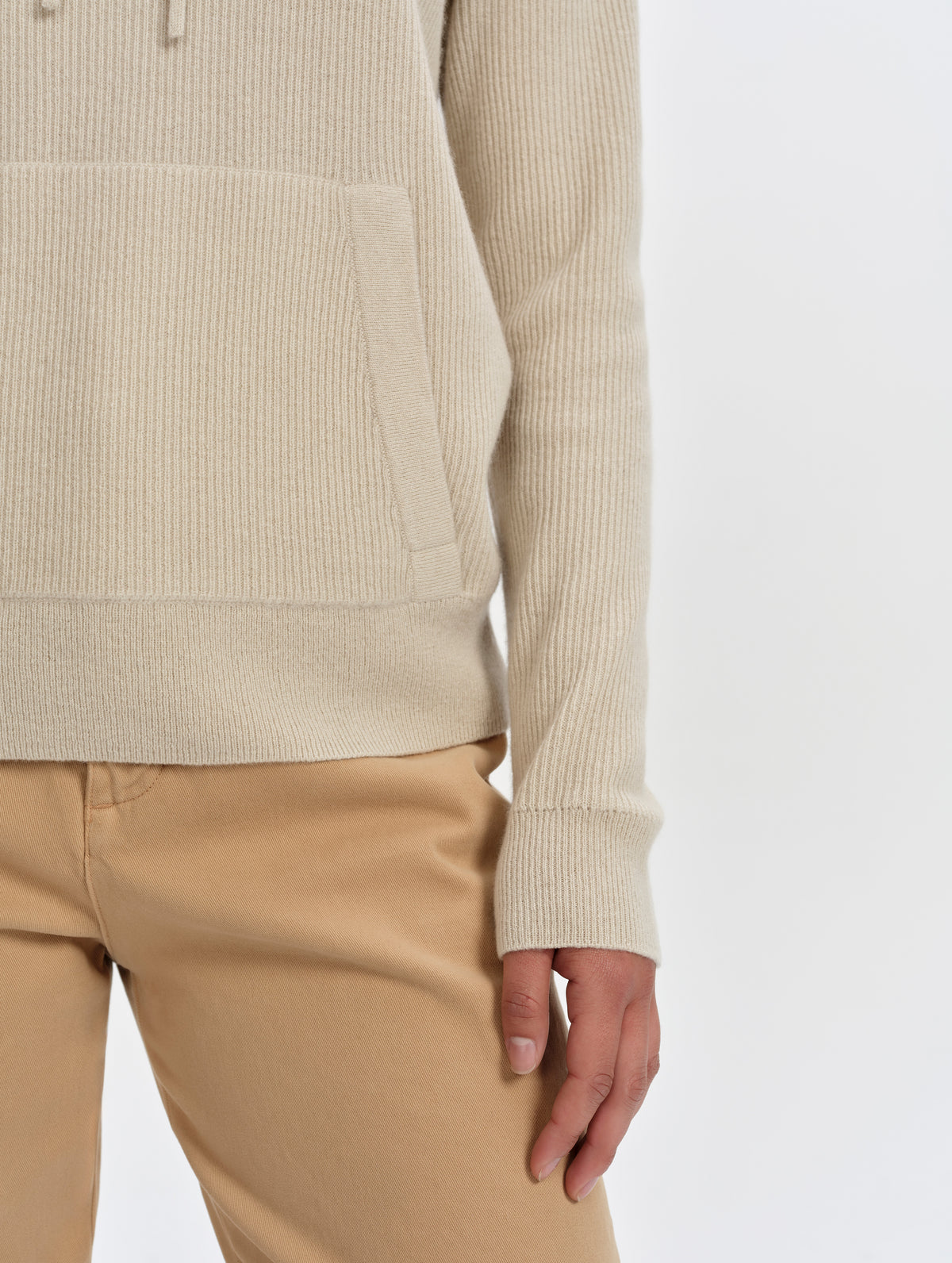 Closeup detailed view of the sleeve cuffs and kangaroo pocket on the Lawrence Cashmere Hooded Sweater in Bone from AETHER Apparel.