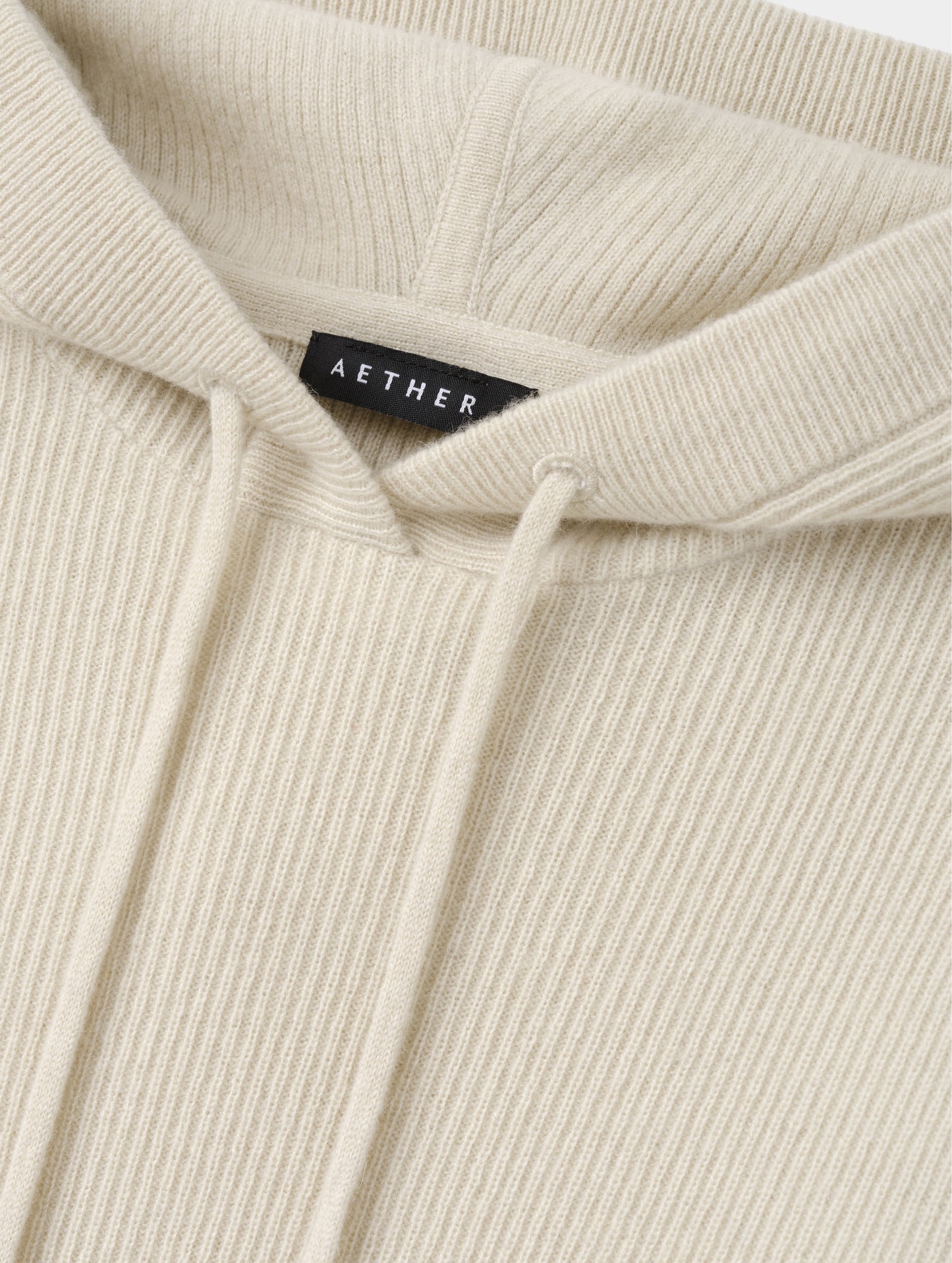 Closeup detailed view of the drawcord on the hood of the Lawrence Cashmere Hooded Sweater in Bone from AETHER Apparel.