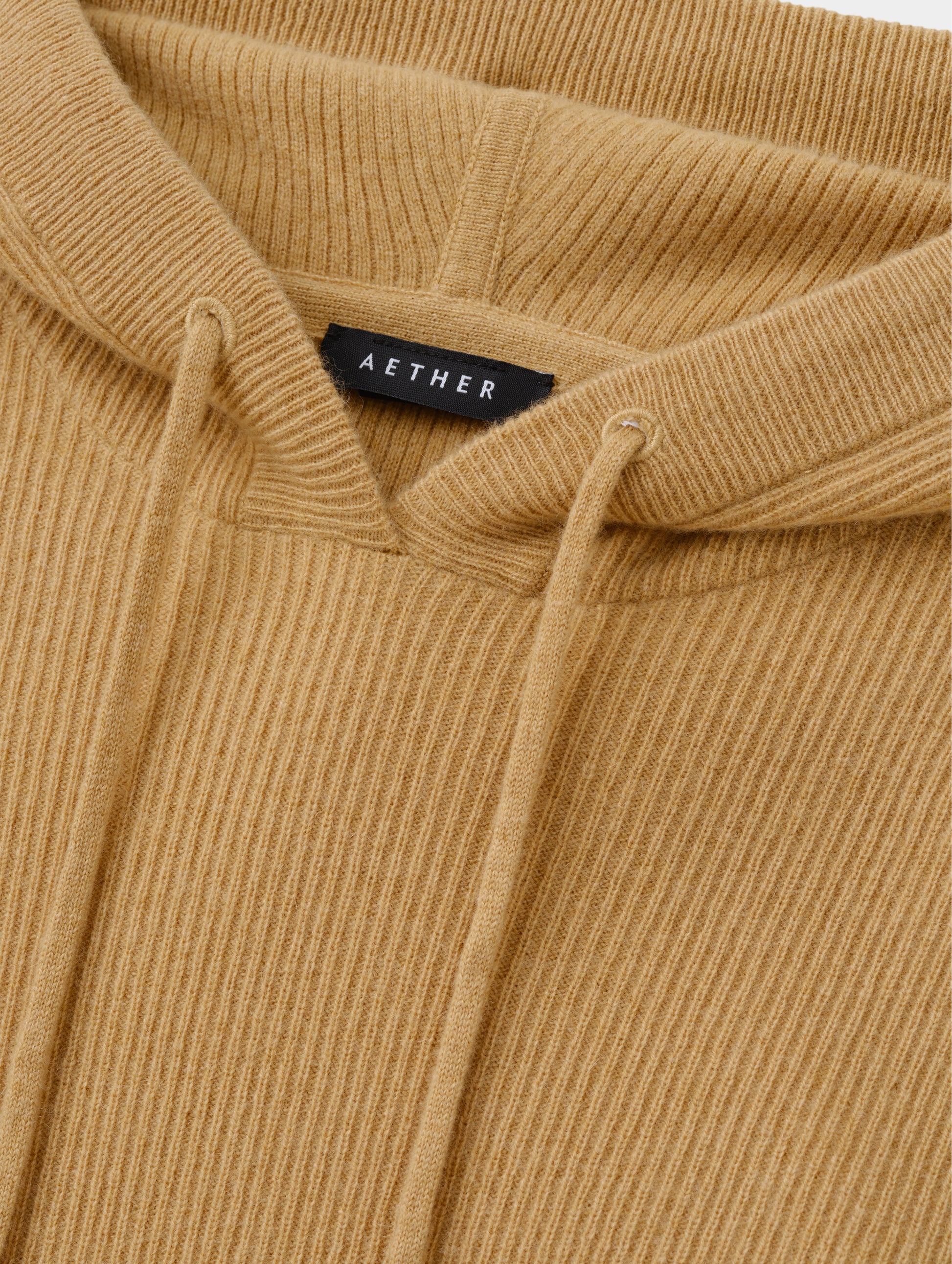 Closeup detailed view of the drawcord on the hood of the Lawrence Cashmere Hooded Sweater in Latte Brown from AETHER Apparel.