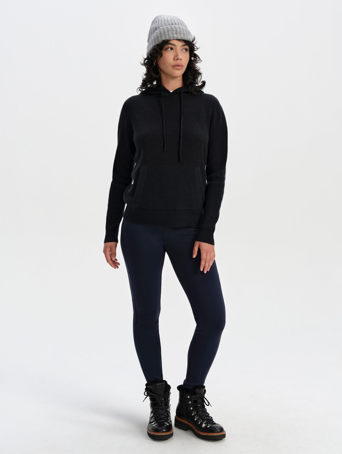 Front full-body view of woman wearing the Lawrence Cashmere Hooded Sweater in Onyx Black from AETHER Apparel.
