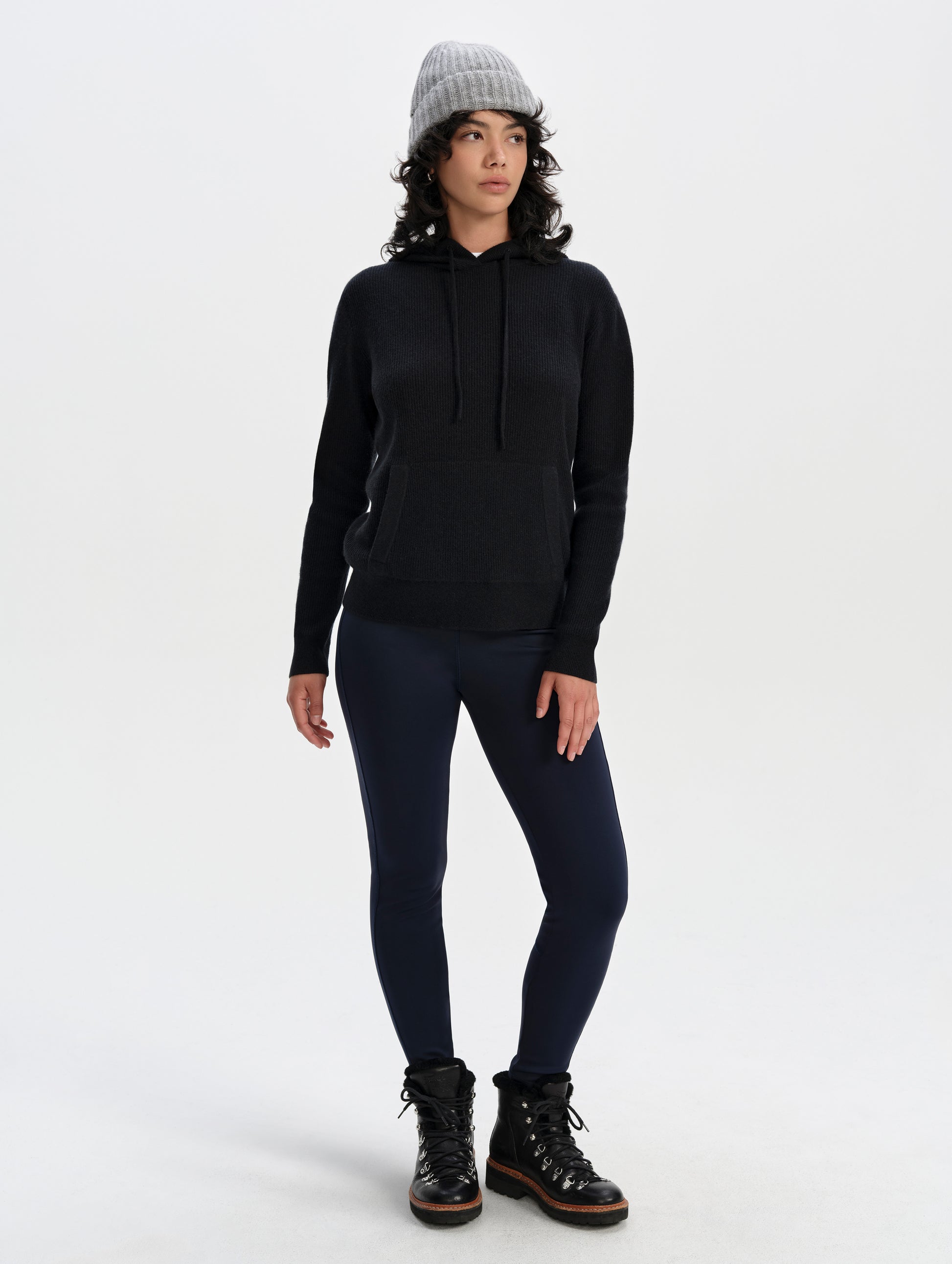 Front full-body view of woman wearing the Lawrence Cashmere Hooded Sweater in Onyx Black from AETHER Apparel.