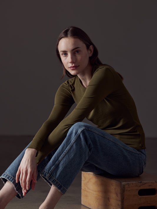 woman wearing green long-sleeve shirt from AETHER Apparel