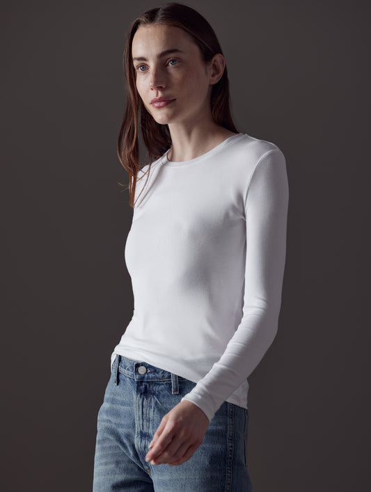 Front angled view of woman wearing Legacy Long-Sleeve Crew in White from AETHER Apparel.