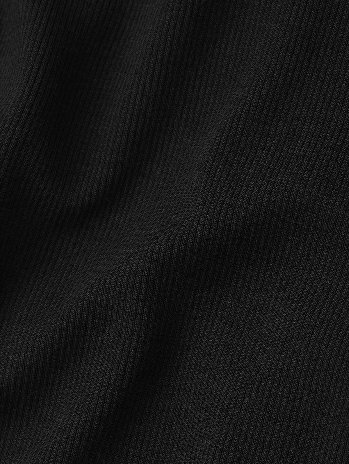 Closeup detailed view of the rib-knit fabric on the Legacy Long-Sleeve Henley in Onyx Black from AETHER Apparel.