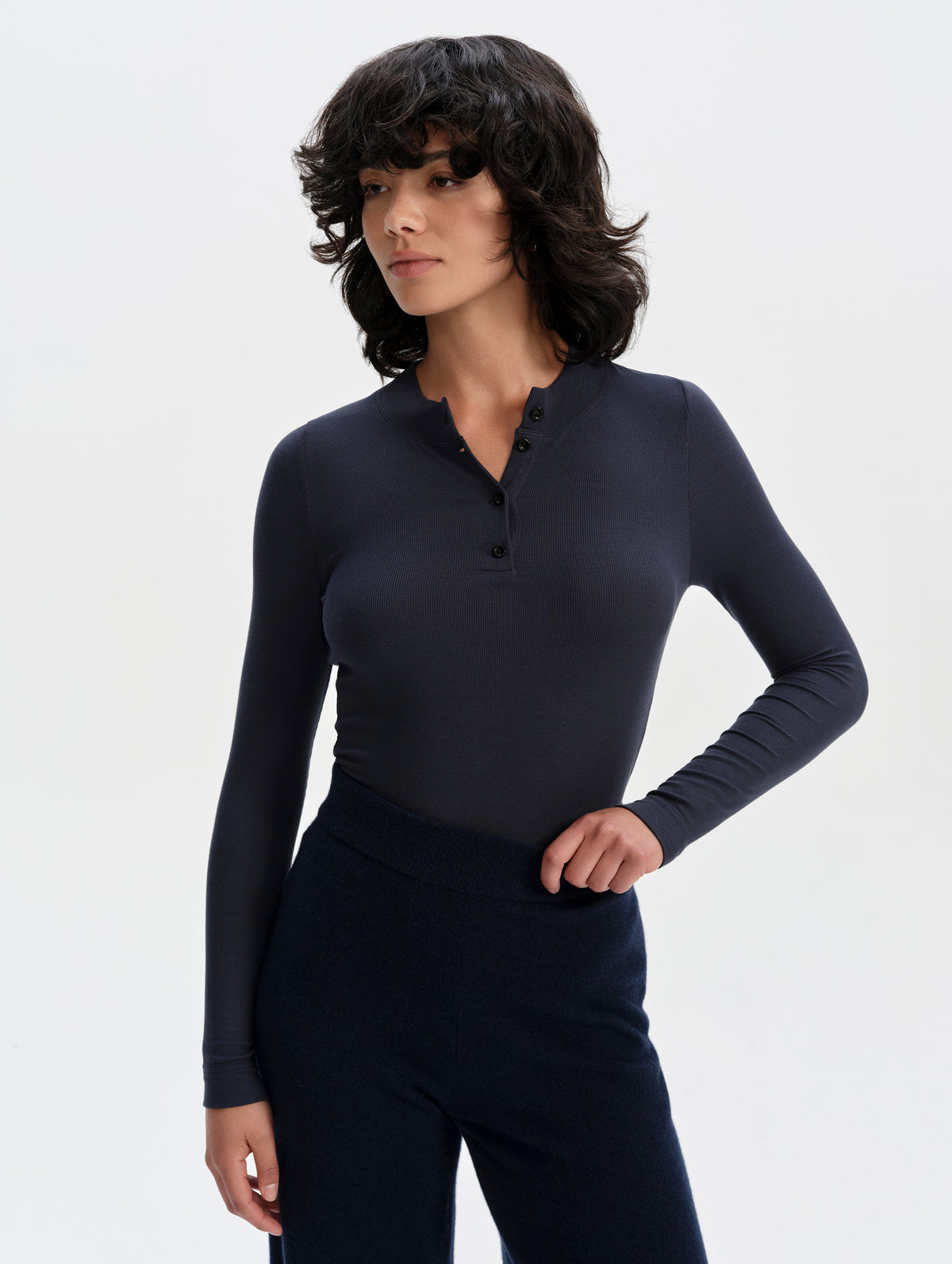 Front upper-body view of woman wearing the Legacy Long-Sleeve Henley in Total Eclipse from AETHER Apparel.
