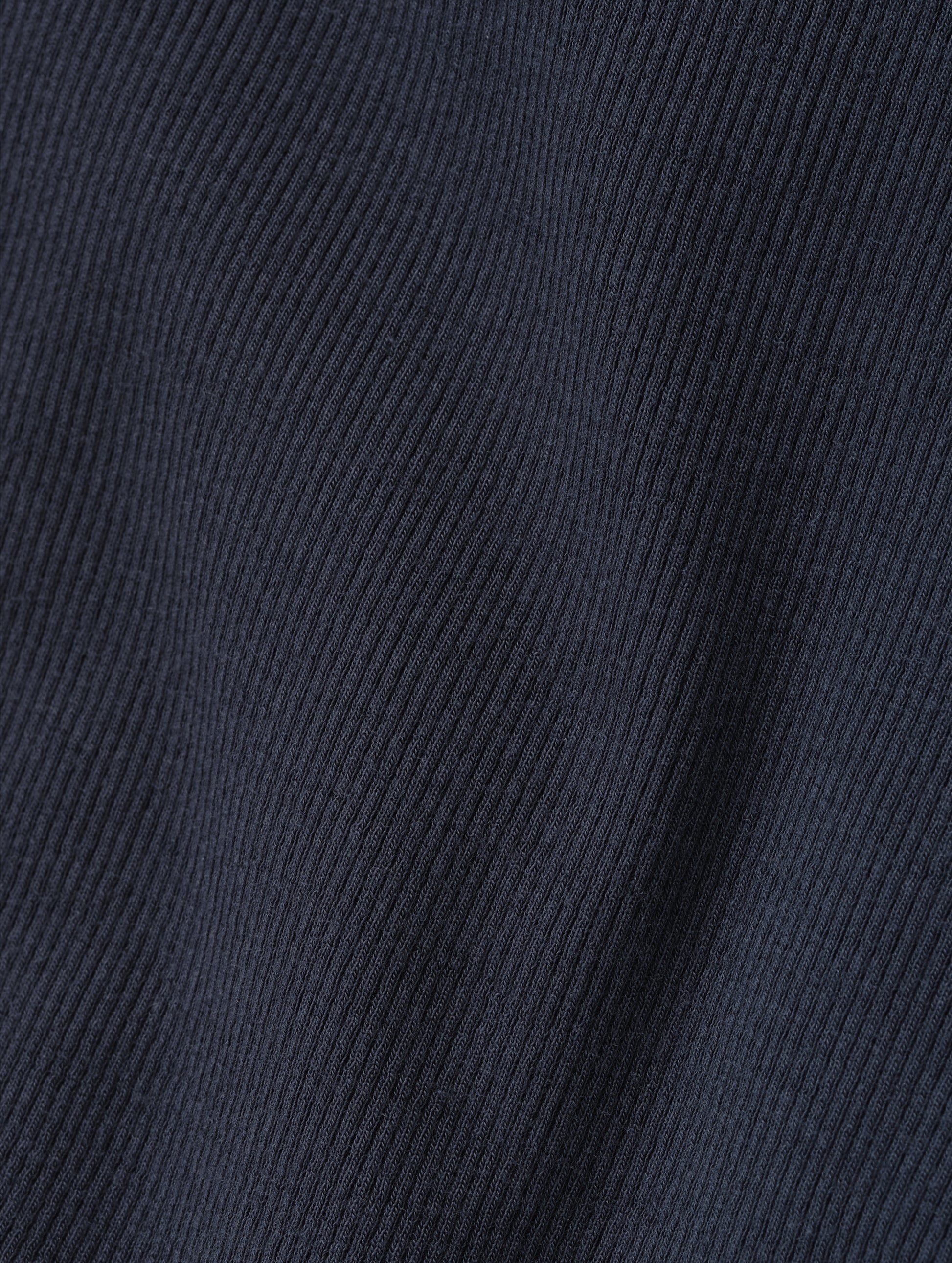 Closeup detailed view of the rib-knit fabric on the Legacy Long-Sleeve Henley in Total Eclipse from AETHER Apparel.