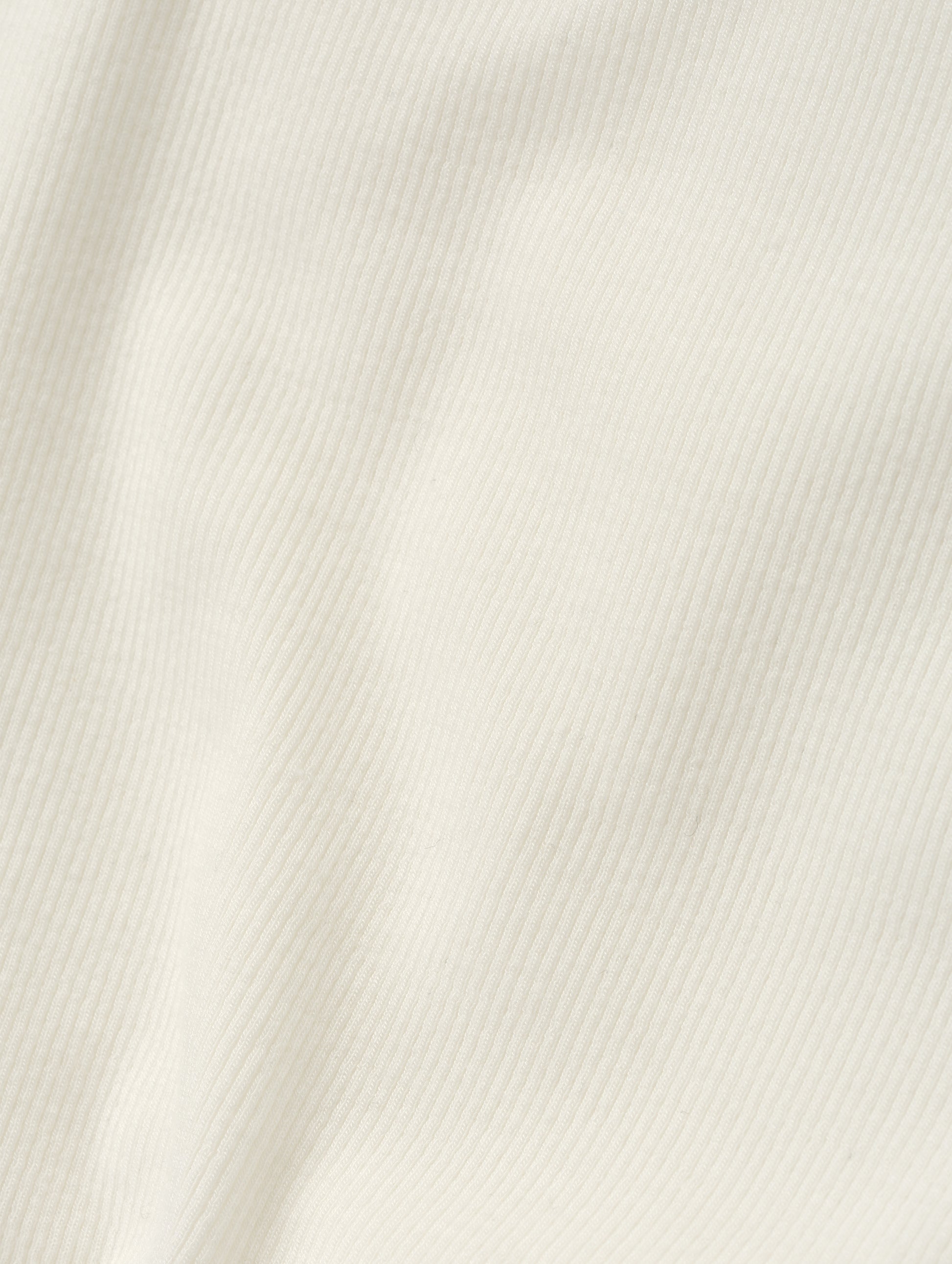 Closeup detailed view of the rib-knit fabric on the Legacy Long-Sleeve Henley in Winter White from AETHER Apparel.