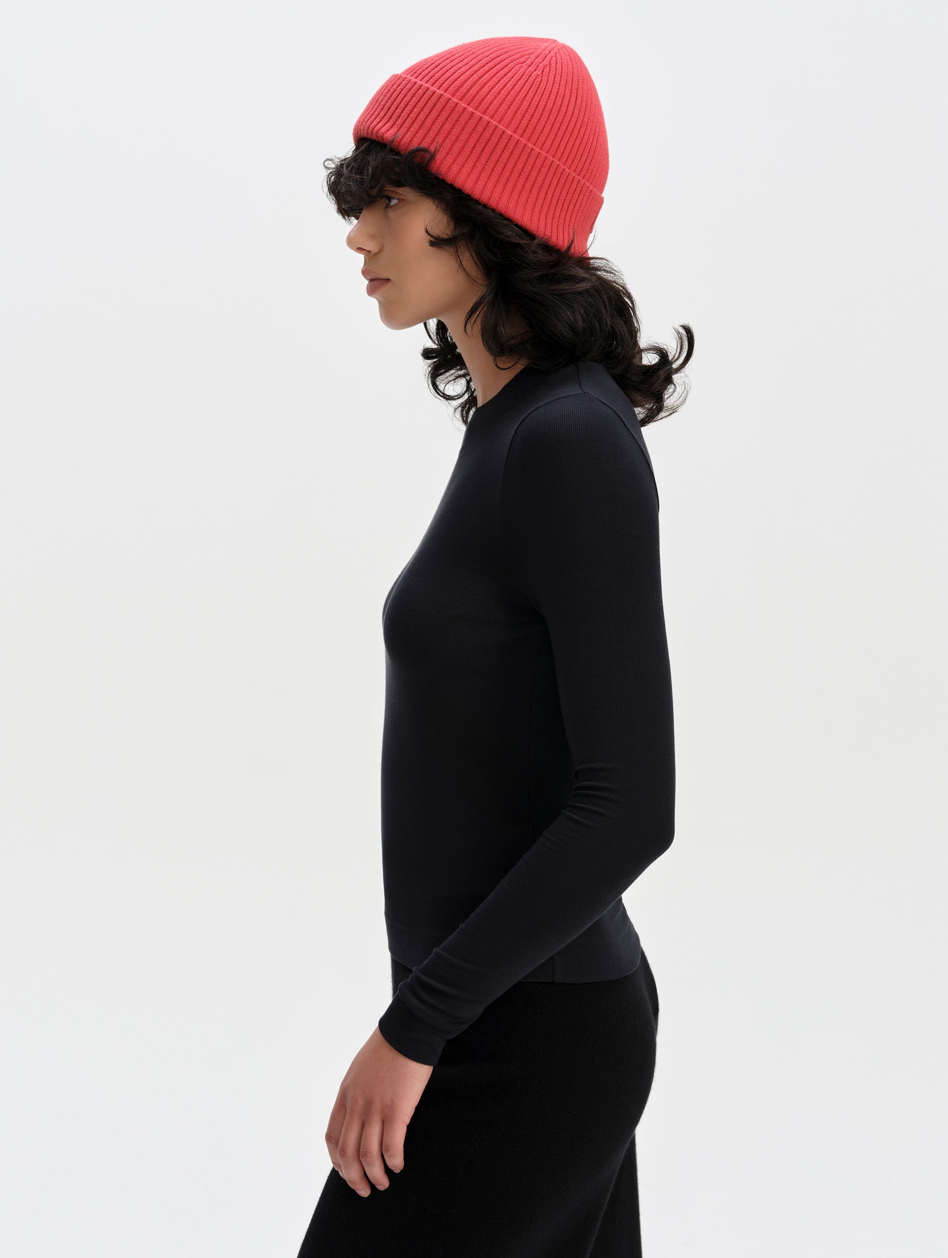 Side profile upper-body view of woman wearing the Legacy Long-Sleeve Shirt in Winter White from AETHER Apparel.