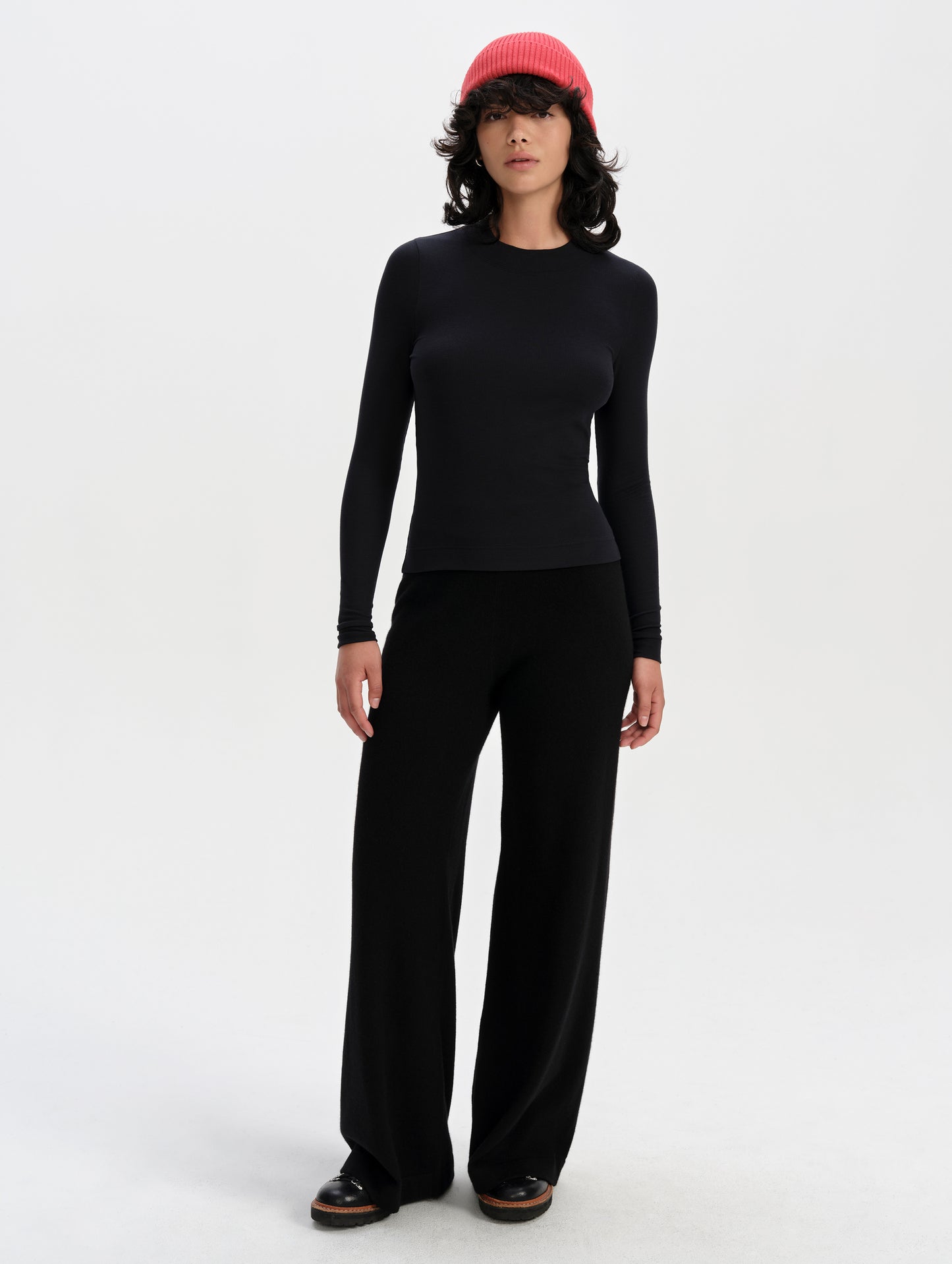 Front full-body view of woman wearing the Legacy Long-Sleeve Shirt in Winter White from AETHER Apparel.