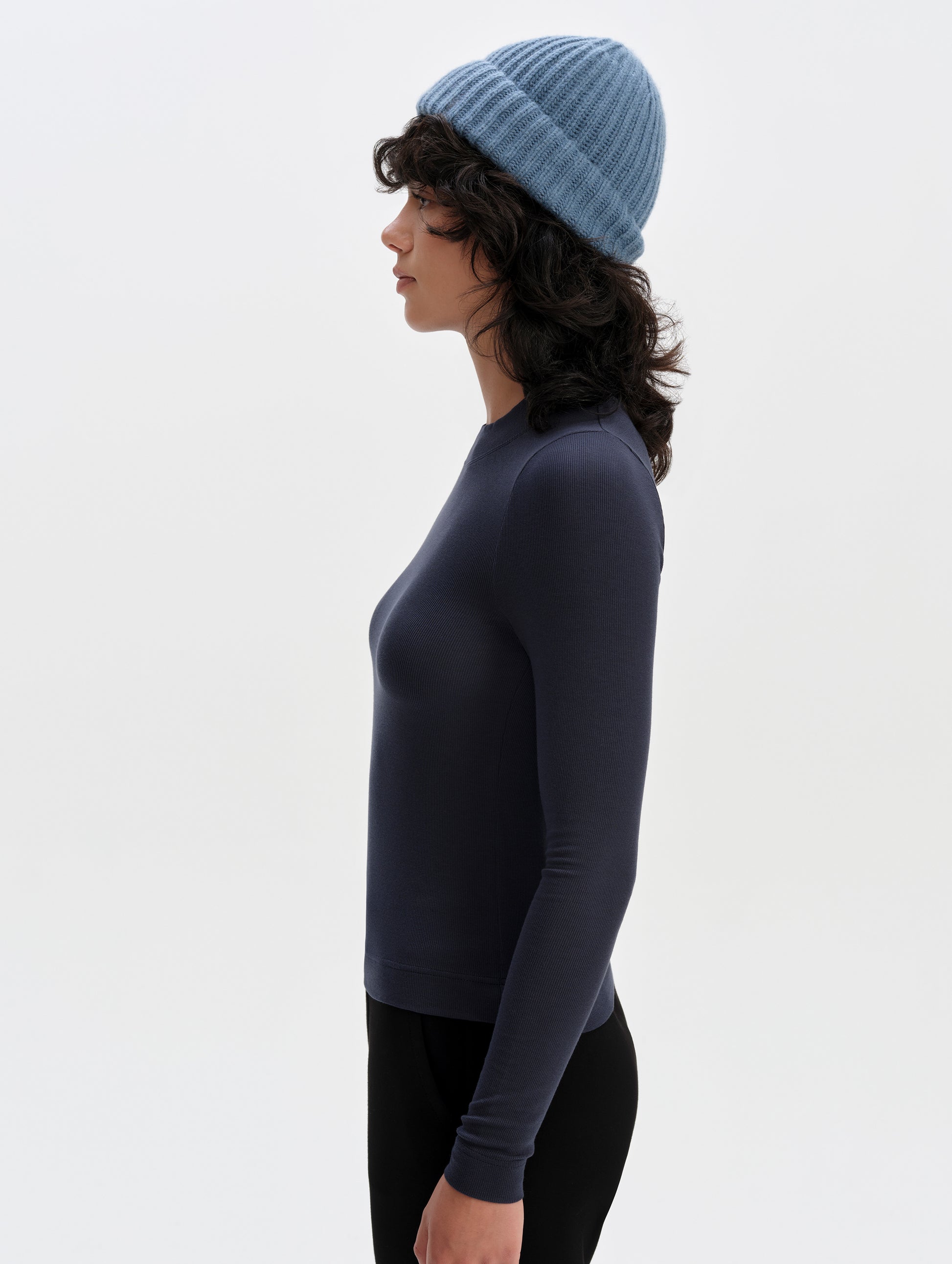 Side profile upper-body view of woman wearing the Legacy Long-Sleeve Shirt in Total Eclipse from AETHER Apparel.