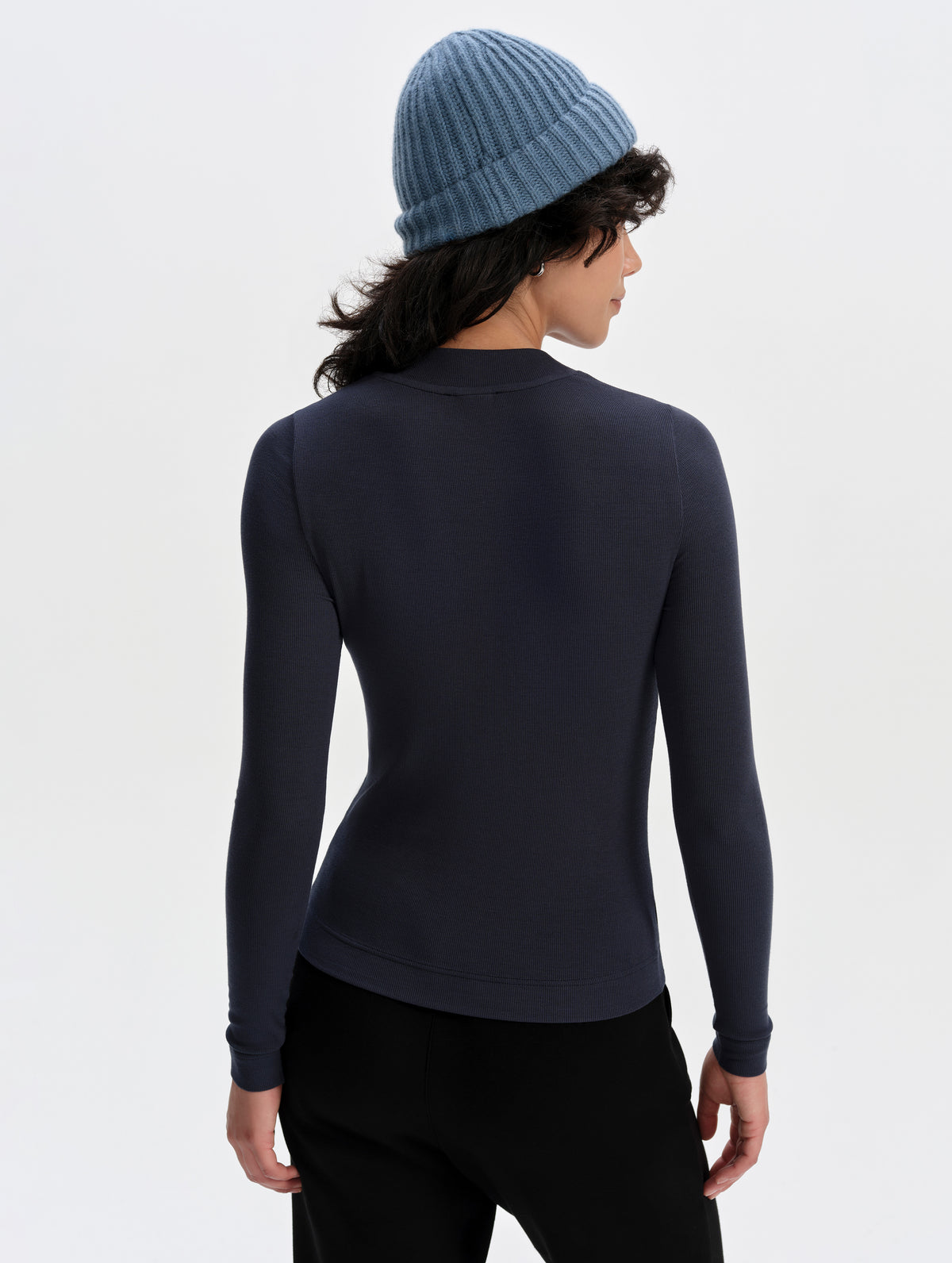 Rear upper-body view of woman wearing the Legacy Long-Sleeve Shirt in Total Eclipse from AETHER Apparel.