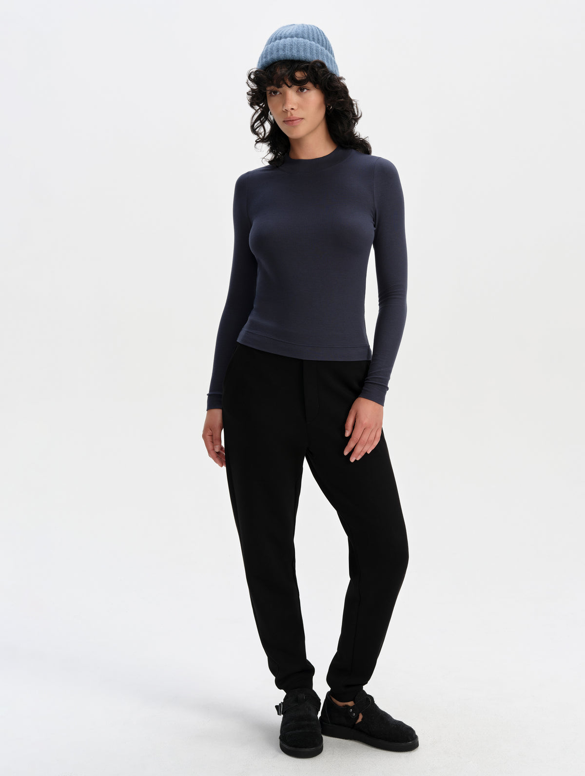 Front full-body view of woman wearing the Legacy Long-Sleeve Shirt in Total Eclipse from AETHER Apparel.