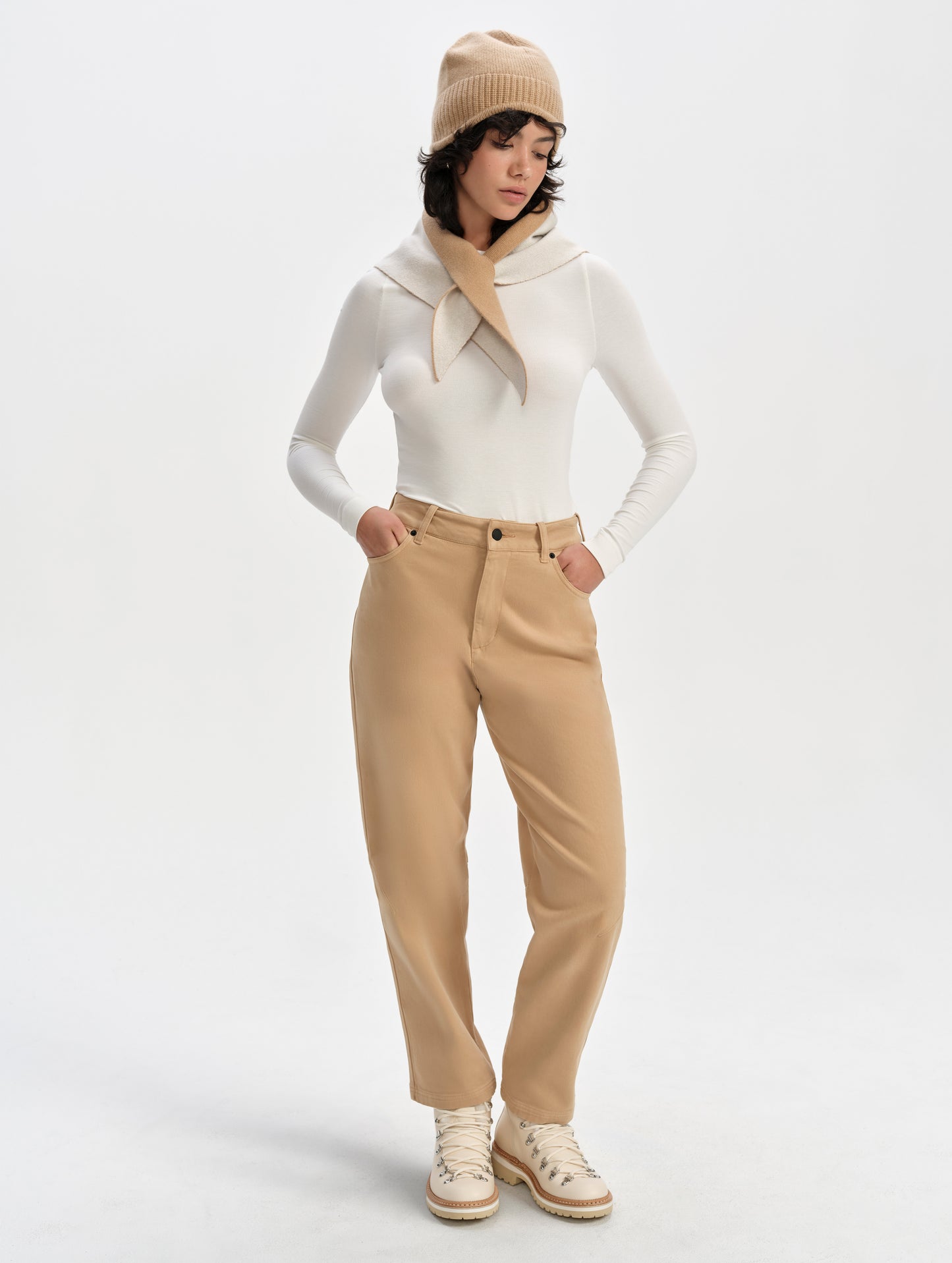 Front full-body view of woman wearing the Legacy Long-Sleeve Shirt in Winter White from AETHER Apparel.