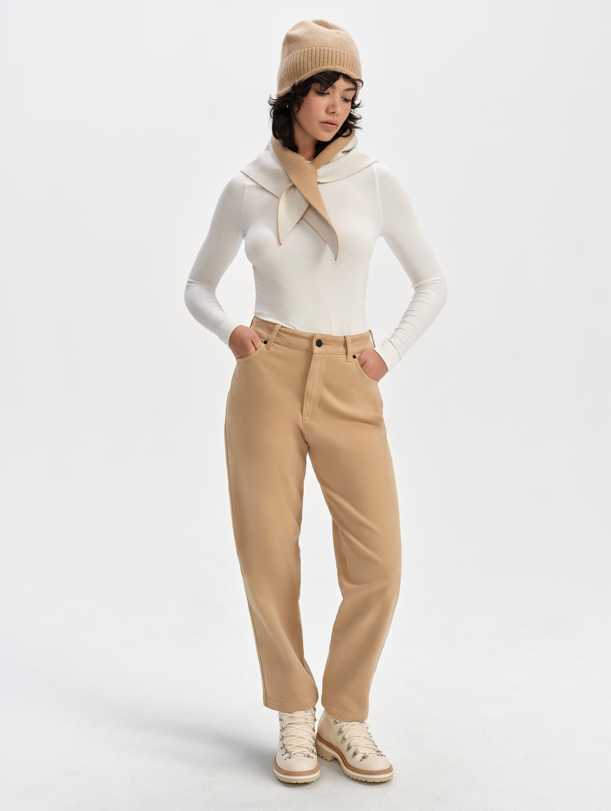 Front full-body view of woman wearing the Legacy Long-Sleeve Shirt in Winter White from AETHER Apparel.
