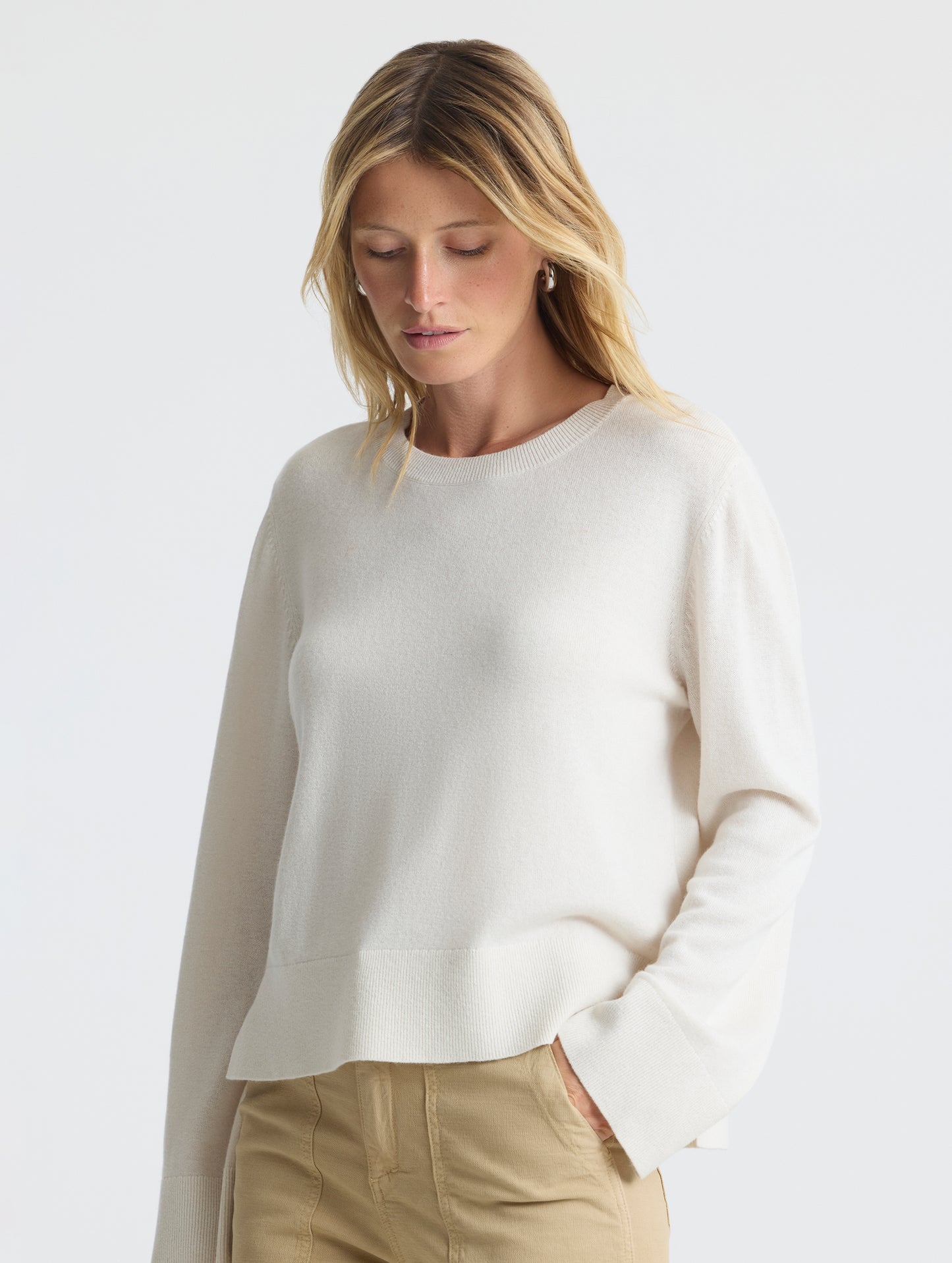 Front angled view of woman wearing Leigh Cashmere Crewneck in Winter White from AETHER Apparel.