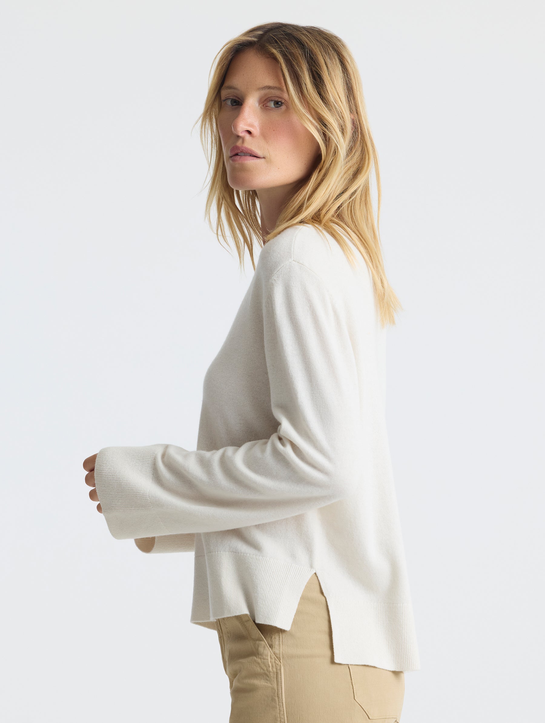 Left side profile of woman wearing Leigh Cashmere Crewneck in Winter White from AETHER Apparel.