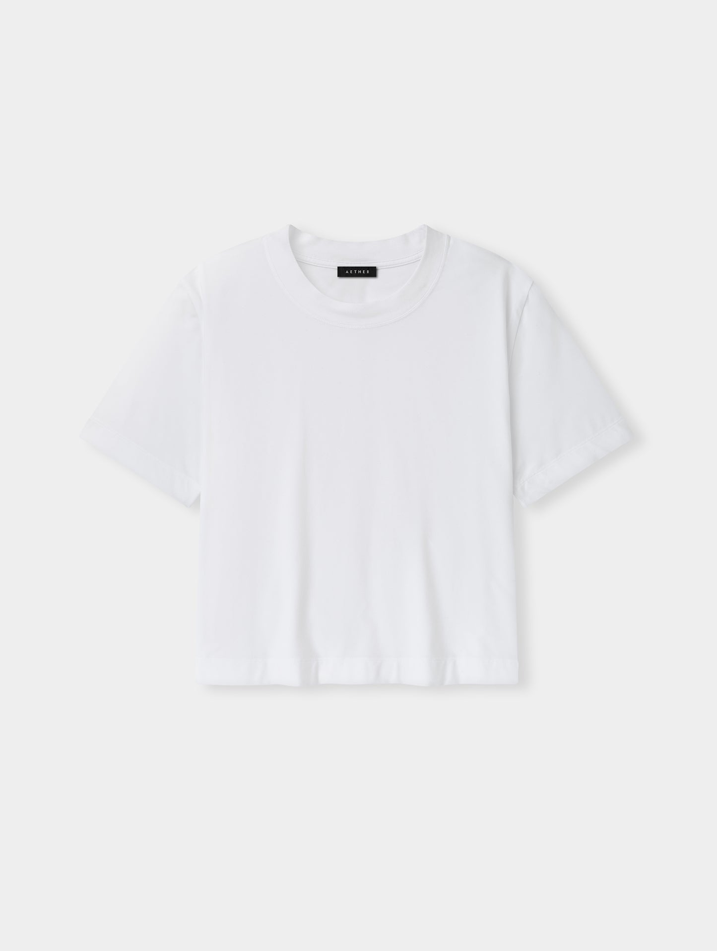 Flat lay view of the Lola Relaxed Tee in White from AETHER Apparel.