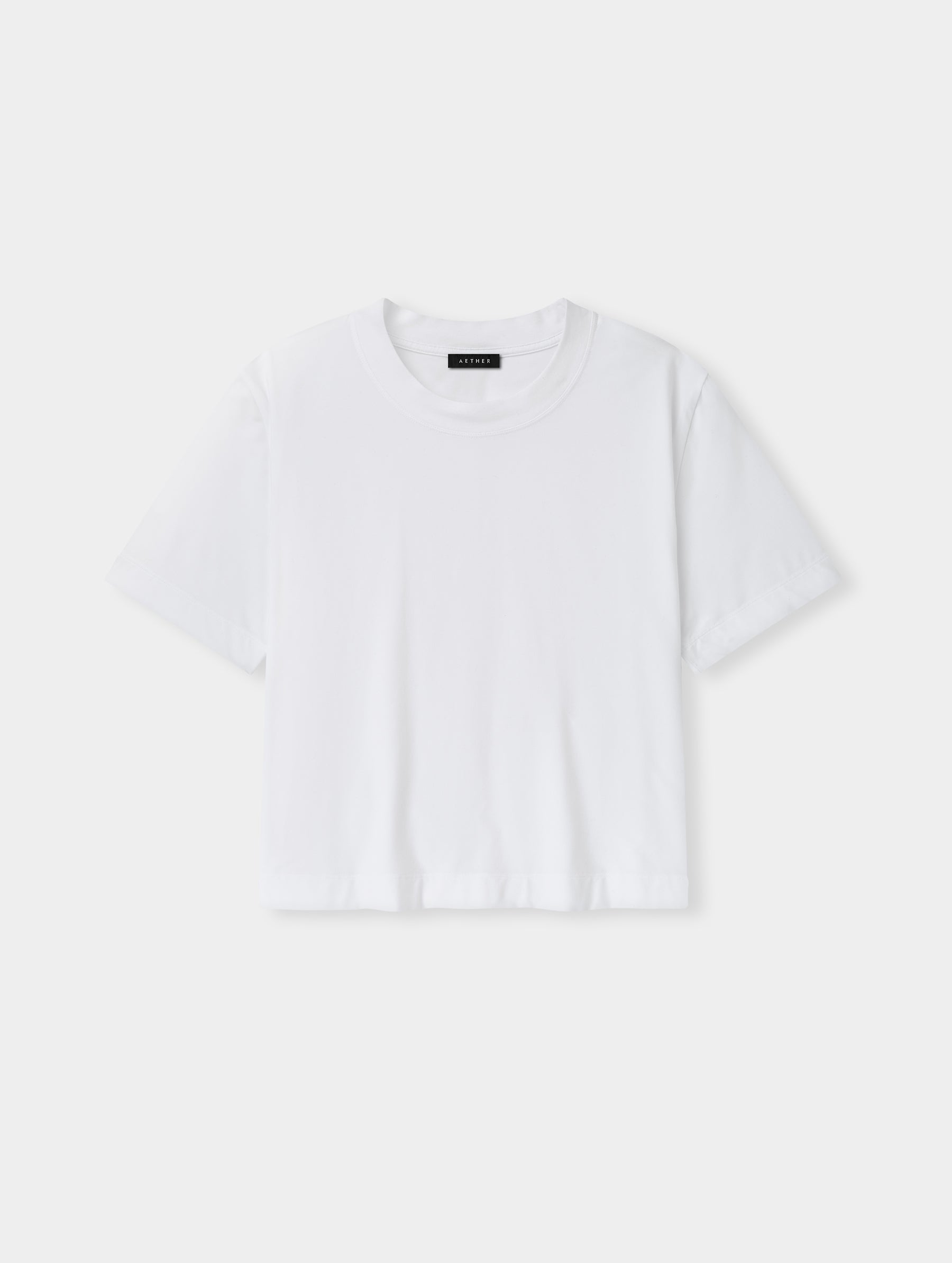 Flat lay view of the Lola Relaxed Tee in White from AETHER Apparel.