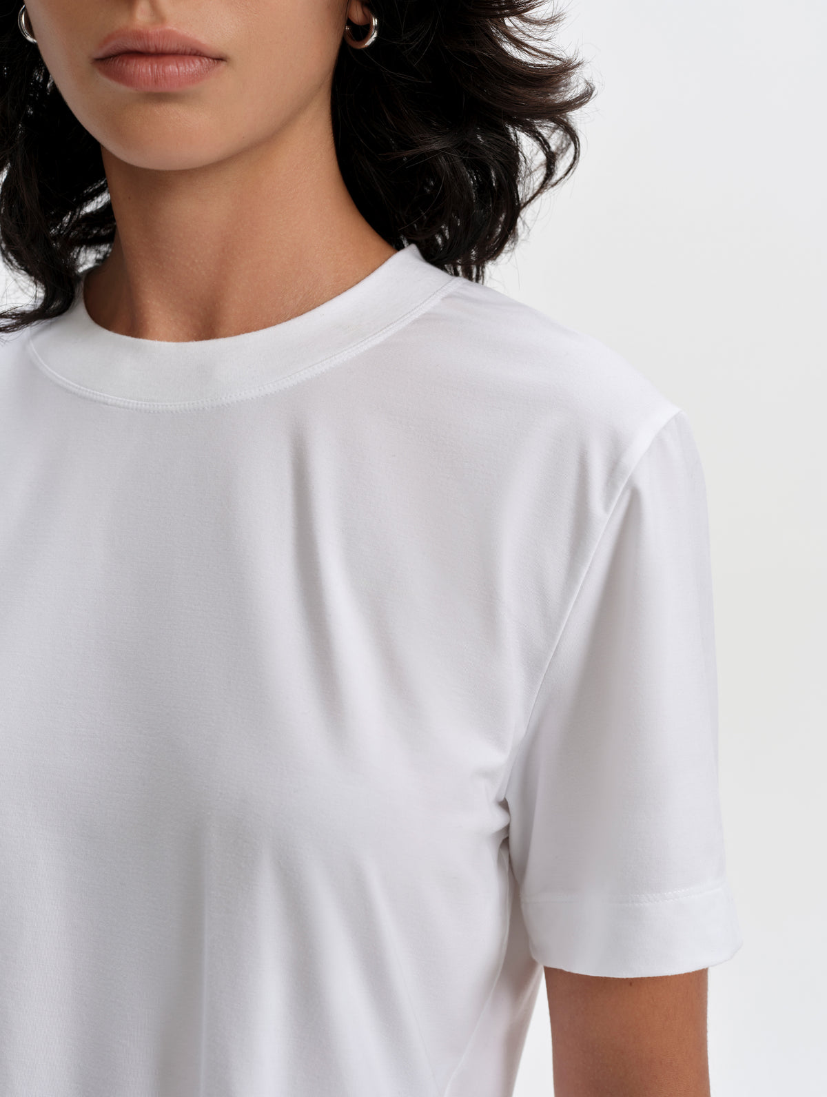 Closeup detailed view of the collar and shoulder seams on the Lola Relaxed Tee in White from AETHER Apparel.