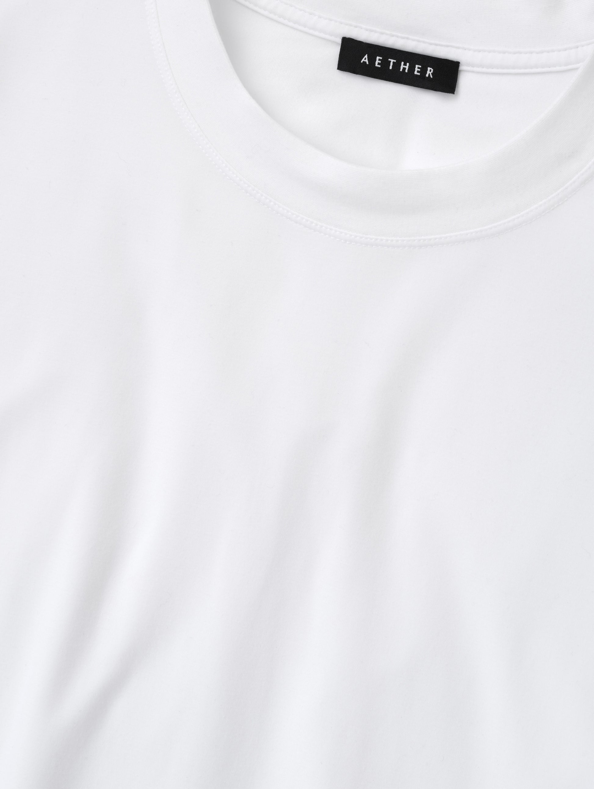 Closeup detailed view of the collar on the Lola Relaxed Tee in White from AETHER Apparel.