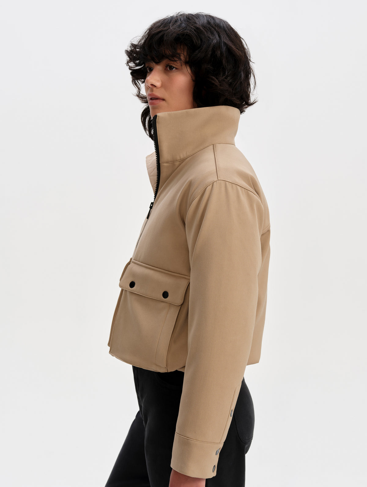 Side profile upper-body view of woman wearing the Luna 3-in-1 Field Jacket in Latte Brown from AETHER Apparel.