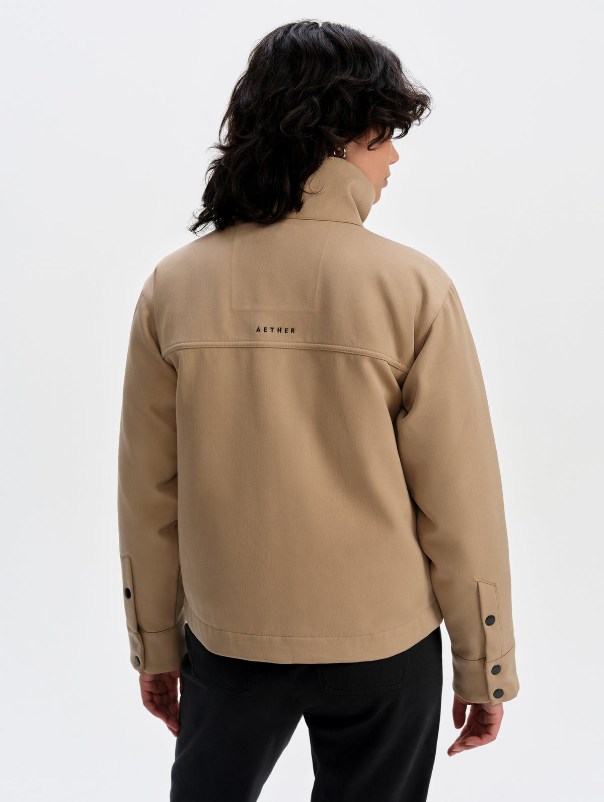 Rear upper-body view of woman wearing the Luna 3-in-1 Field Jacket in Latte Brown from AETHER Apparel.