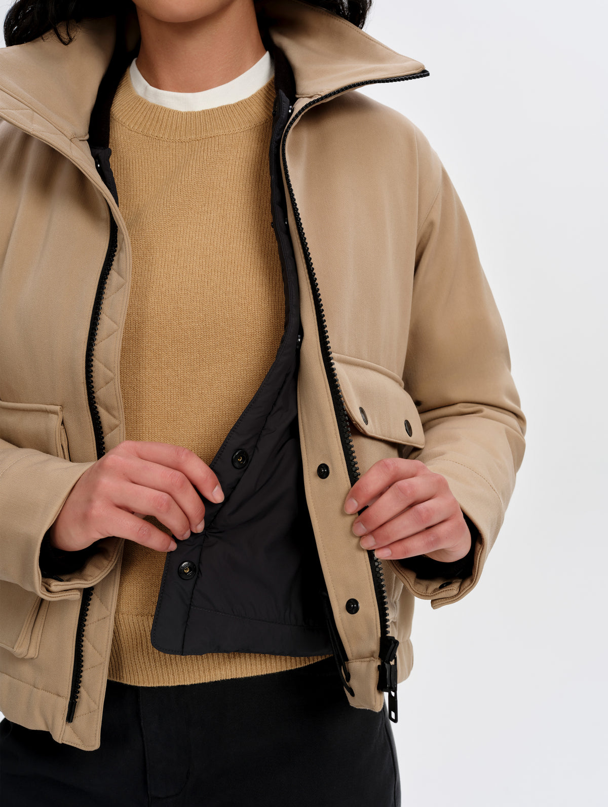 View of the Lock-In Layering snap system connecting the Luna 3-in-1 Field Jacket in Latte Brown from AETHER Apparel to its removable insulated thermal liner. 