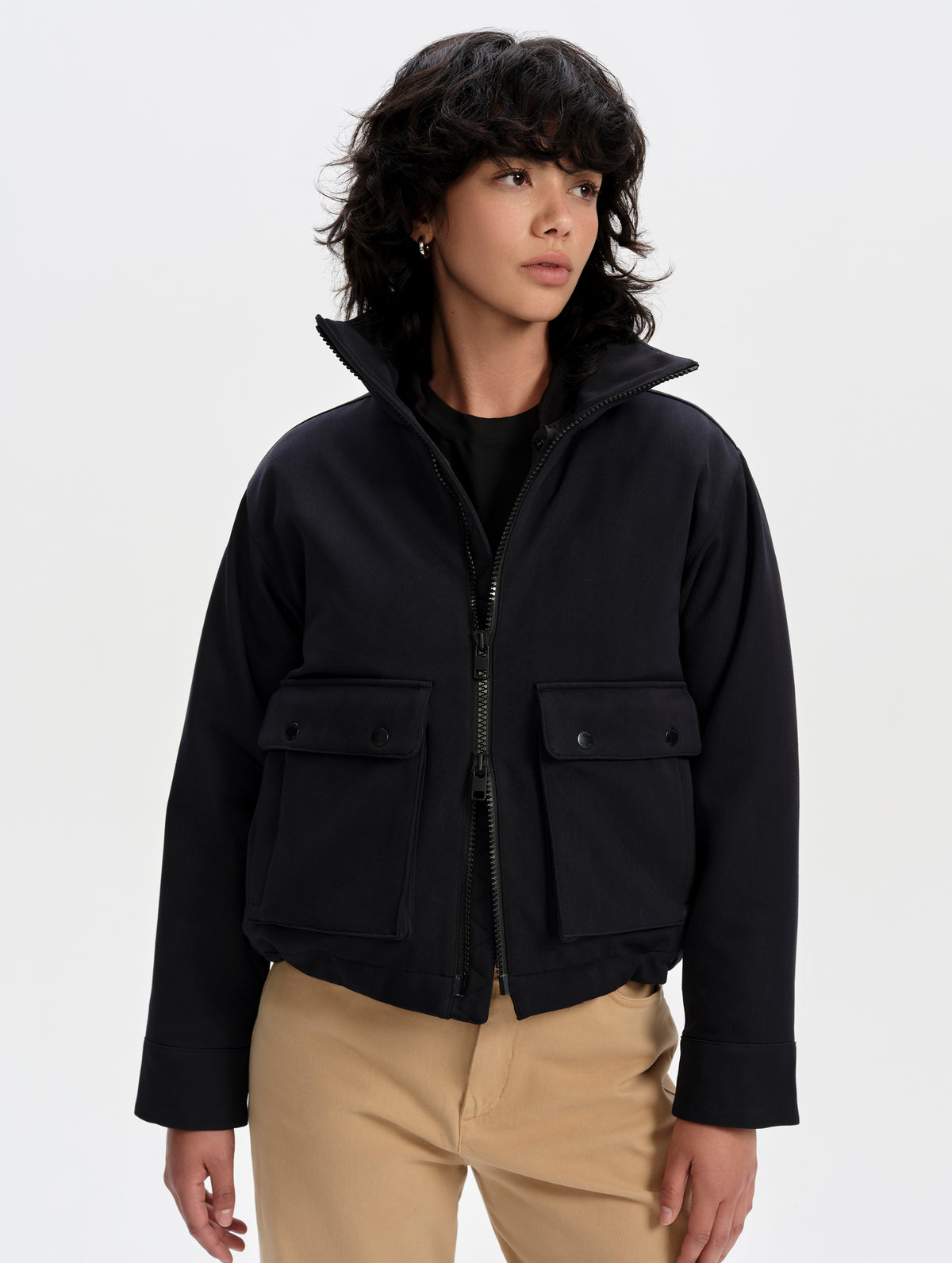 Front upper-body view of woman wearing the Luna 3-in-1 Field Jacket in Onyx Black from AETHER Apparel.