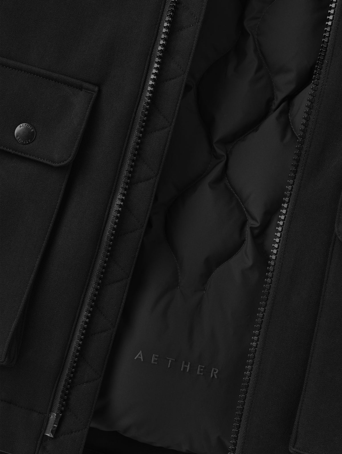 Closeup detailed view of the removable insulated thermal liner on the Luna 3-in-1 Field Jacket in Onyx Black from AETHER Apparel. 