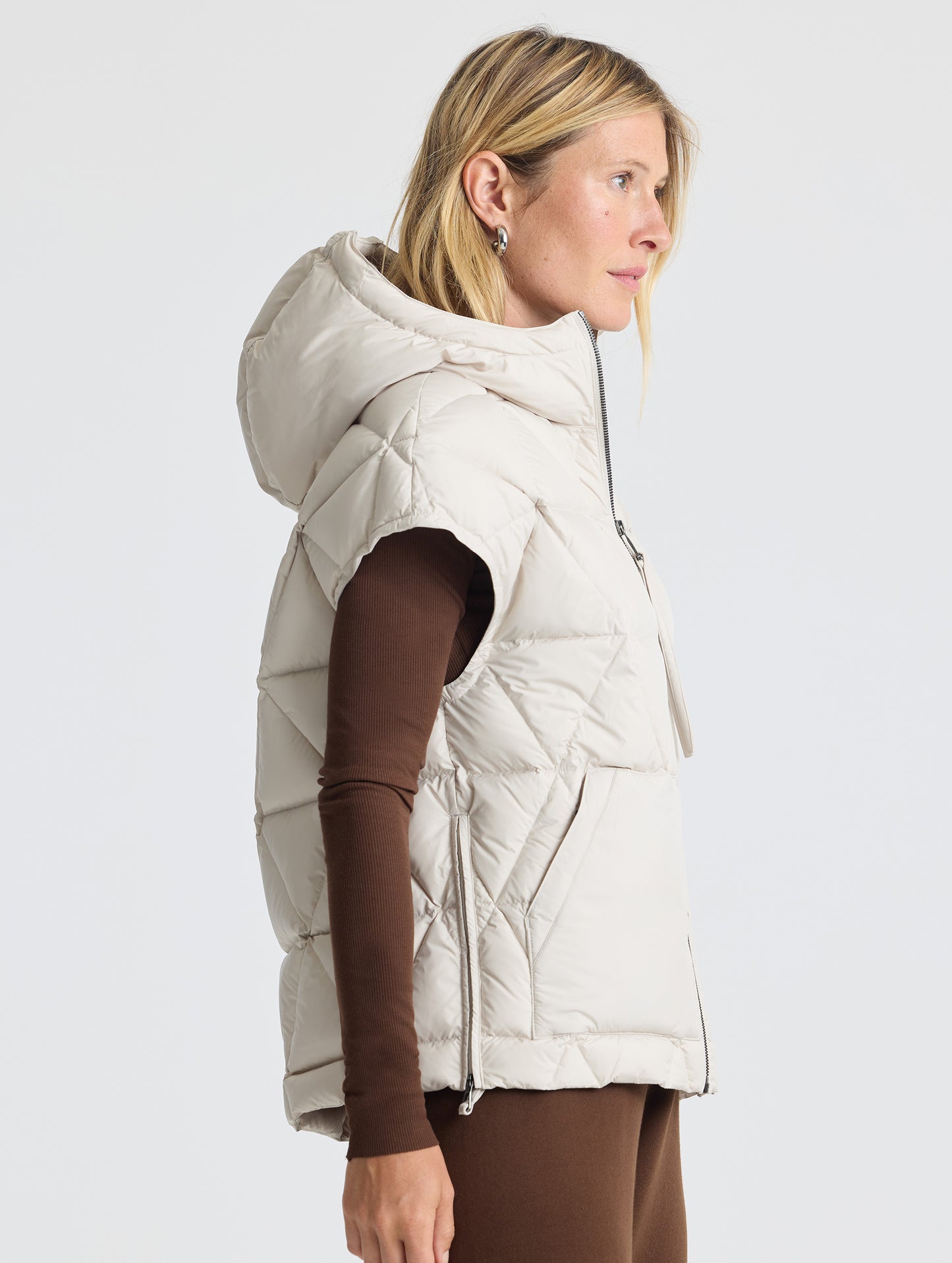 Right profile view of woman wearing Mailen Oversized Vest in Bone White from AETHER Apparel.