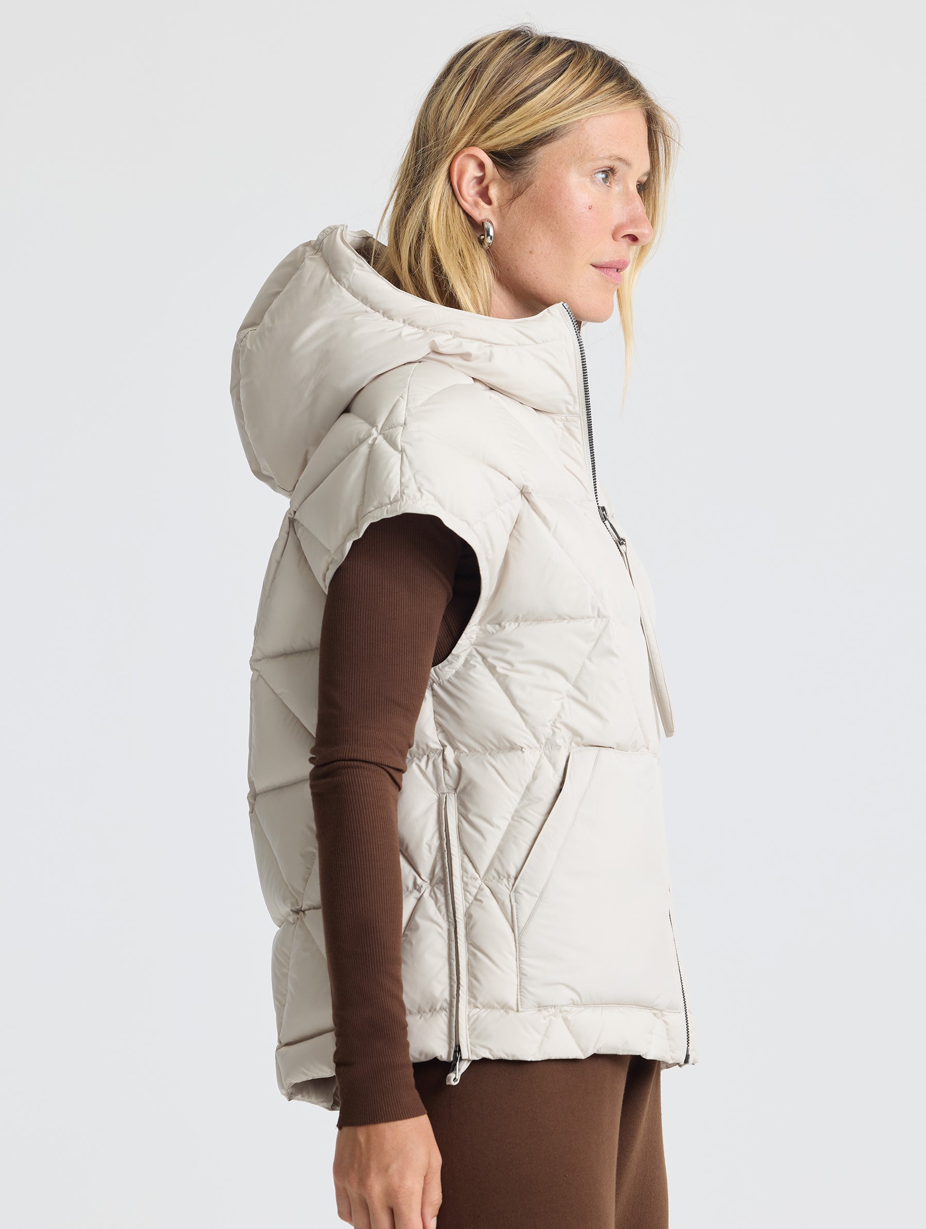 Right profile view of woman wearing Mailen Oversized Vest in Bone White from AETHER Apparel.