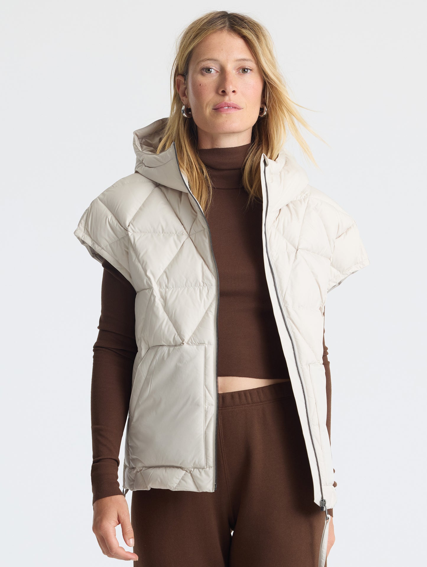 Upper body view of woman wearing unzipped Mailen Oversized Vest in Bone White from AETHER Apparel.