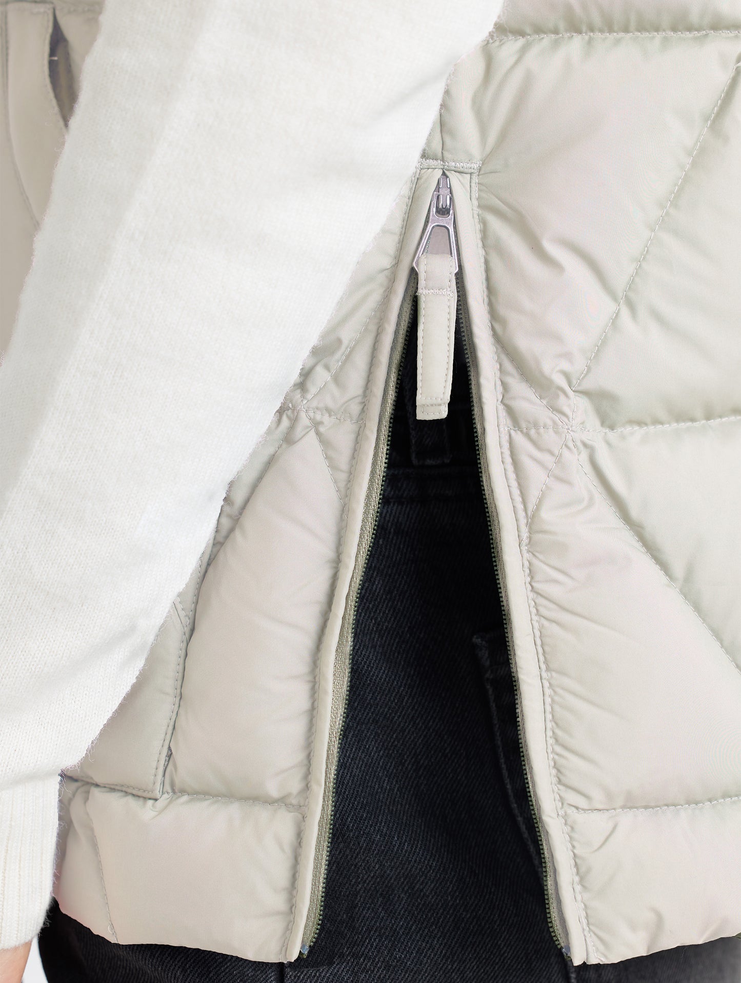 Left side hem opening of Mailen Oversized Vest in Bone White from AETHER Apparel.