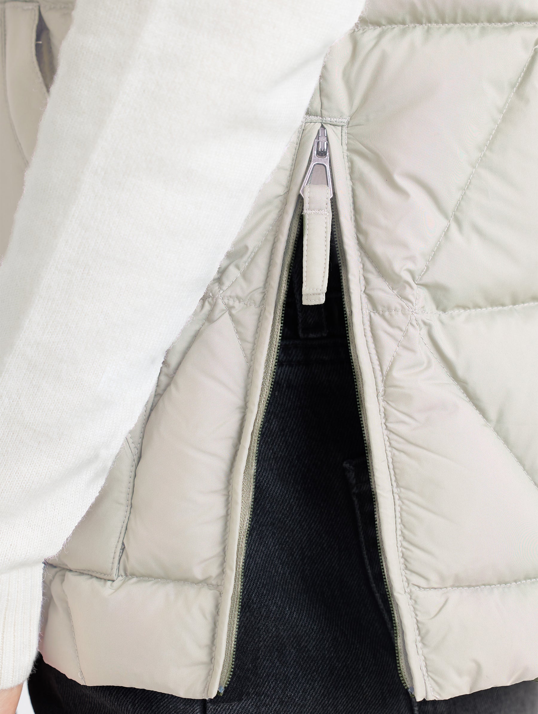 Left side hem opening of Mailen Oversized Vest in Bone White from AETHER Apparel.