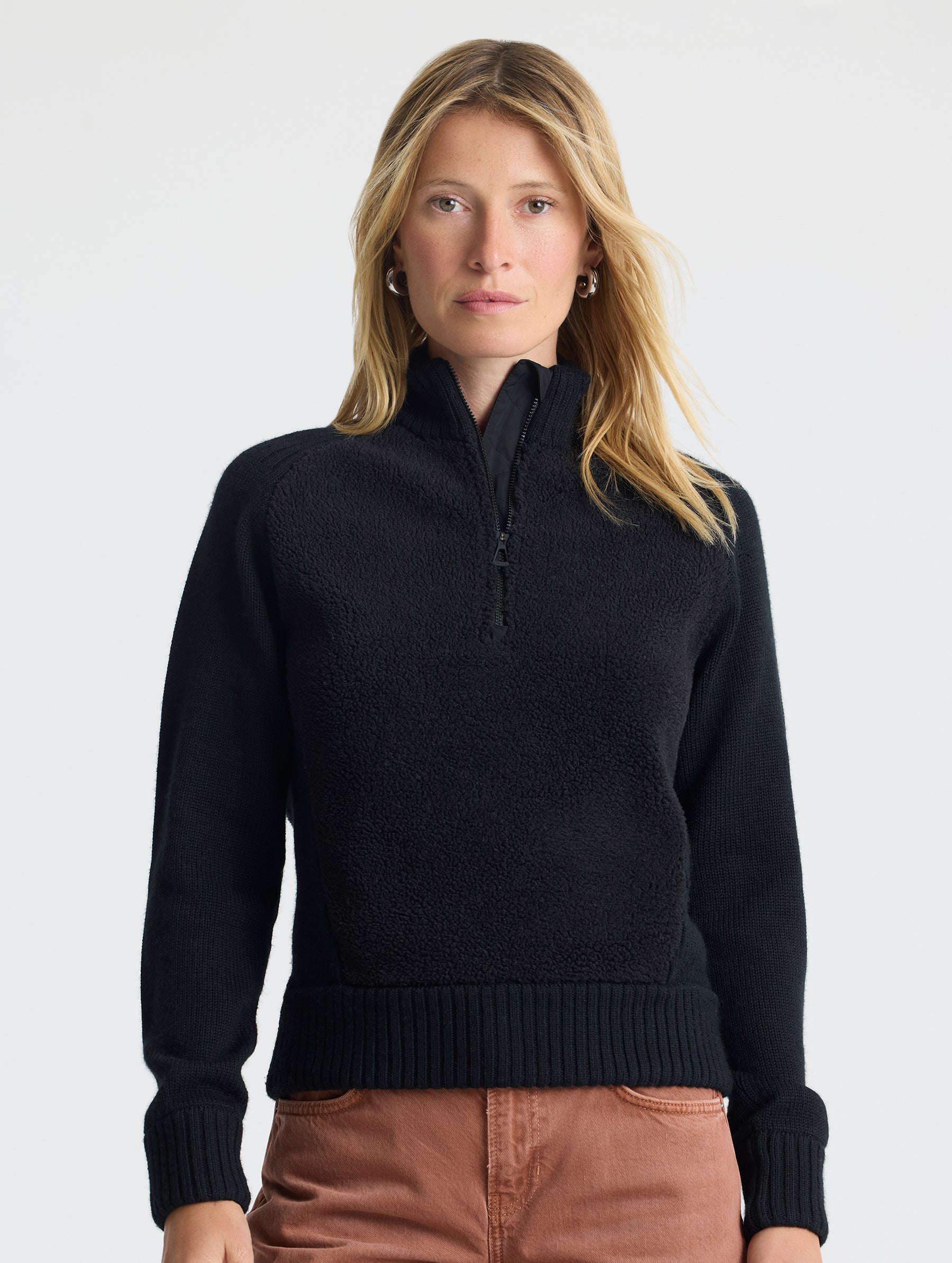 Upper body view of woman wearing Malina Half-Zip Sweater in Onyx Black from AETHER Apparel.