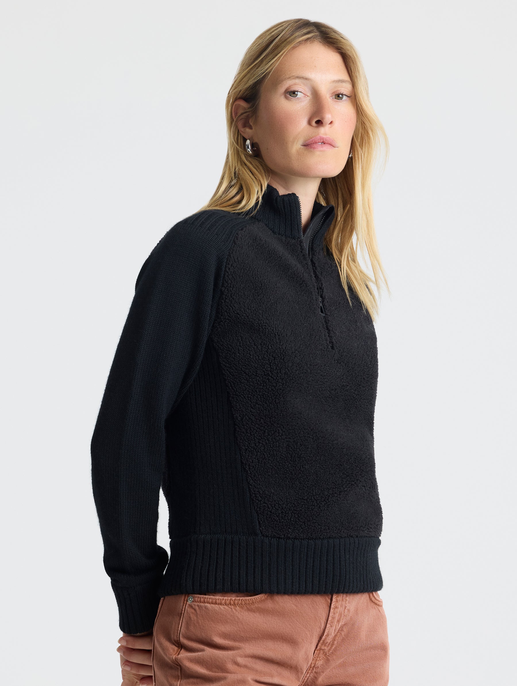 Front angled view of woman wearing Malina Half-Zip Sweater in Onyx Black from AETHER Apparel.