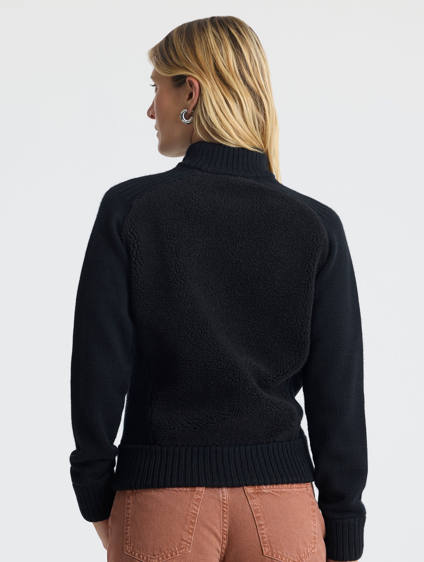 Rear view of woman wearing Malina Half-Zip Sweater in Onyx Black from AETHER Apparel.